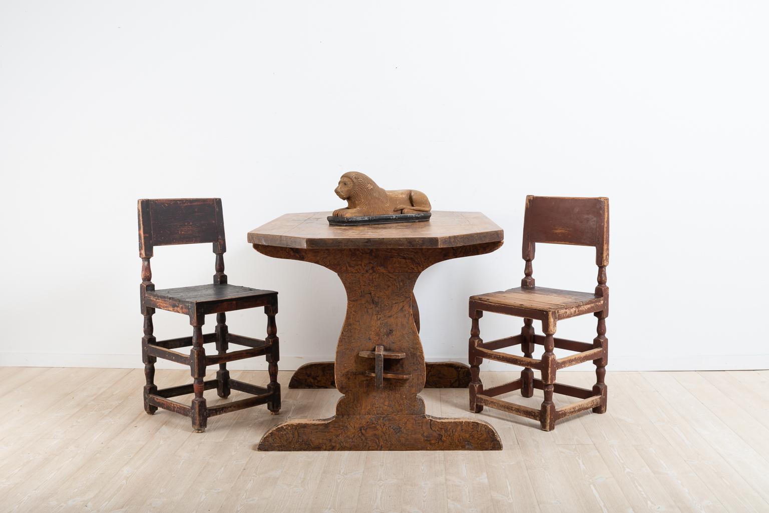 Swedish Folk Art dining table. The model is one of the older and the table has a robust construction. Detached tabletop resting on a leg frame of two trestles. Original imitation paint and an untouched original surface with good patina over the