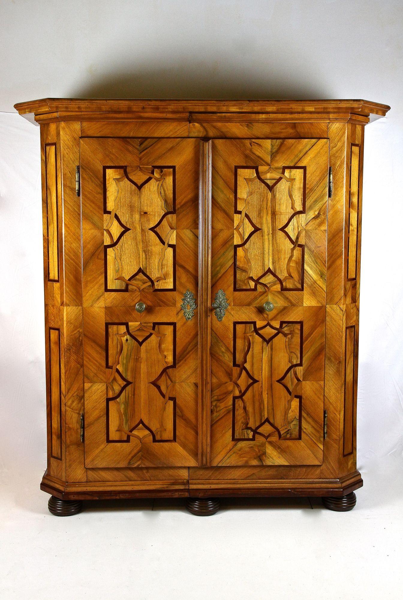 Absolutely beautiful 18th century nutwood baroque cabinet coming from a private castle in Austria. An artfully designed baroque cabinet which has been elaborately crafted in the period around 1780. The fantastic looking inlay works with nut, oak and