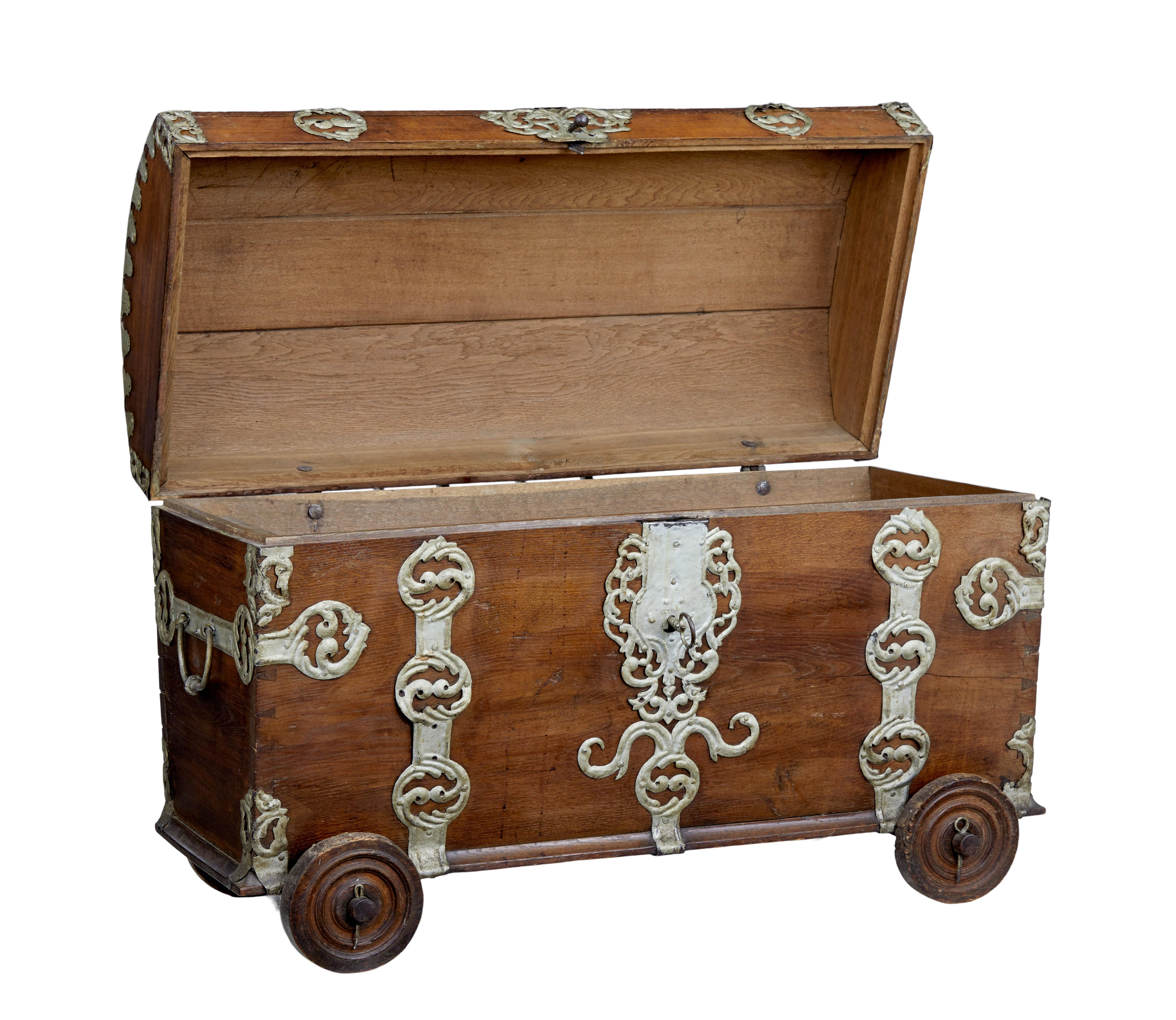 Beautiful and rare oak dome top trunk, circa 1780.

Decorative piece made from character oak. Dome topped and embellished with ornate metal strap work, and original carrying handles to the sides.

Mounted on original wheels, held in place with