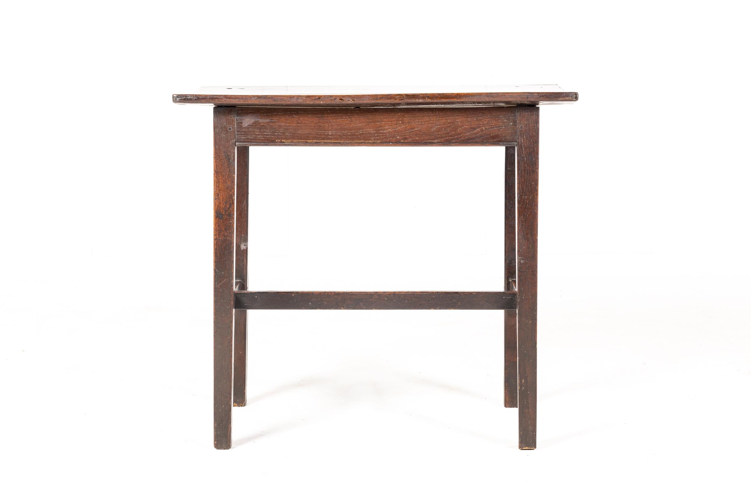An unusual mid-18th century oak centre table/tavern table with a two plank top. Having a simple, traditional frieze raised on square tapering legs united by an unusually high H-stretcher.
A practical, nice sized table with wonderful colour and