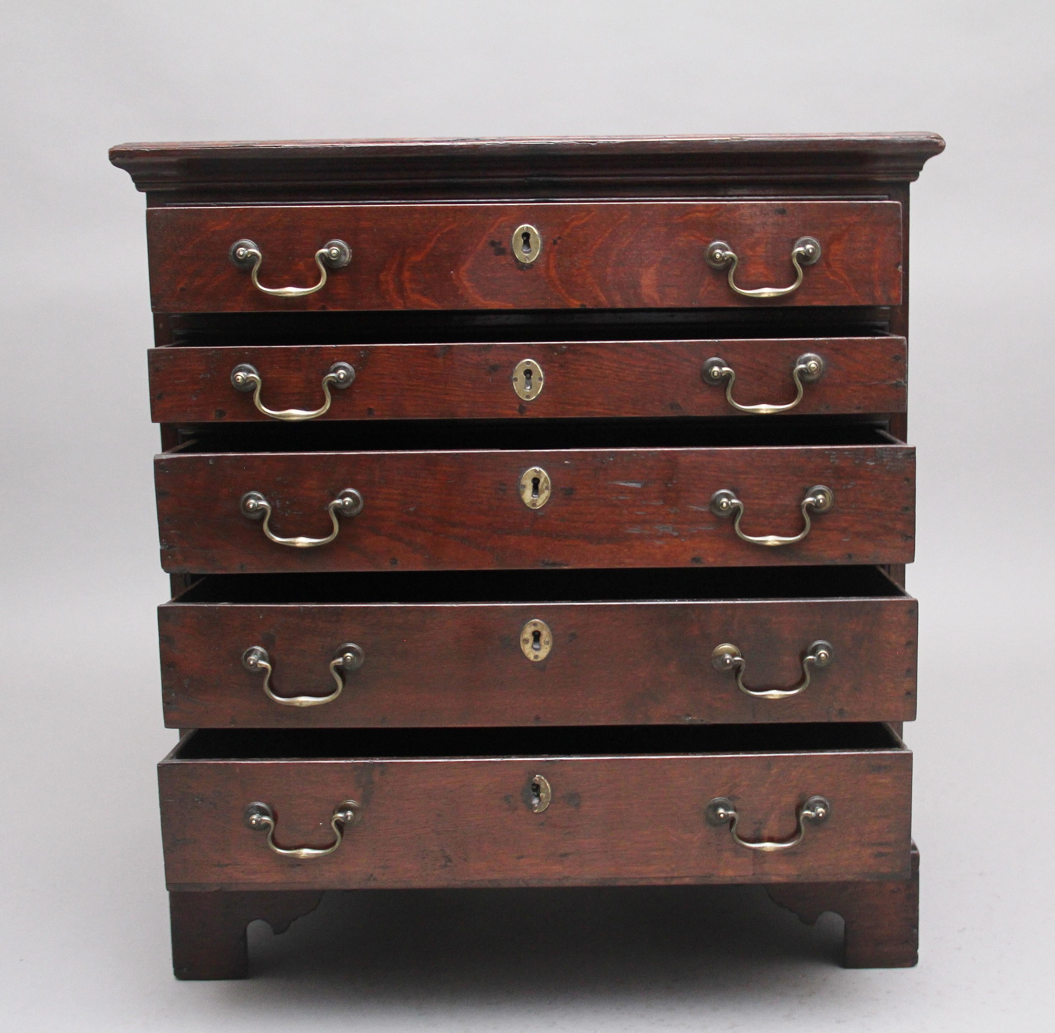 Mid 18th century oak chest of drawers, the double moulded edge top above a selection of five long drawers with brass swan neck handles and escutcheons, supported on bracket feet. Having a lovely patina and in great condition. Circa 1770.