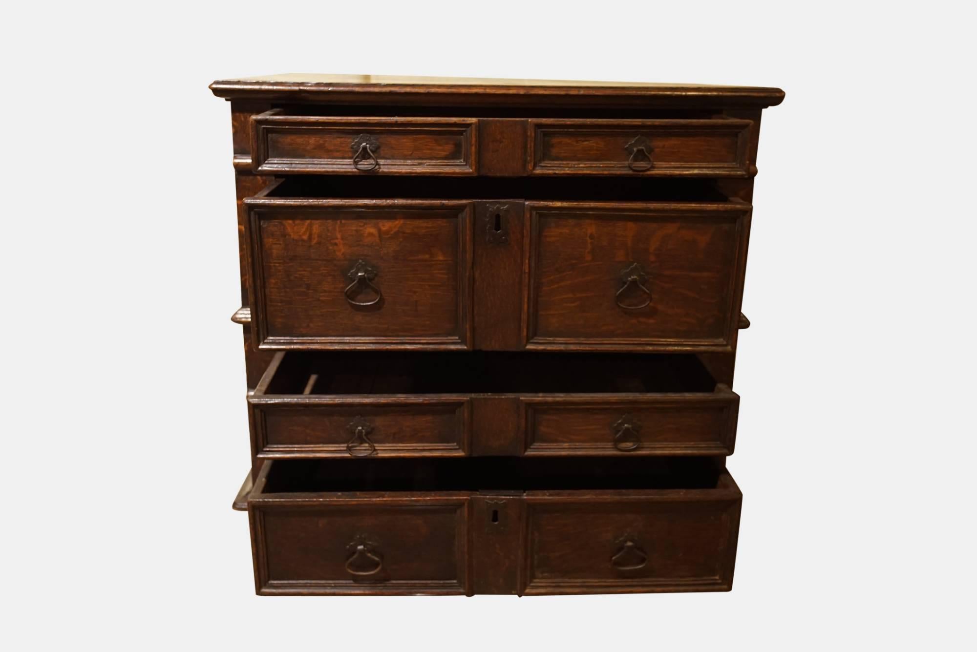 Good color early 18th century oak chest of drawers. Four graduated drawers with applied moldings. Splits into two.