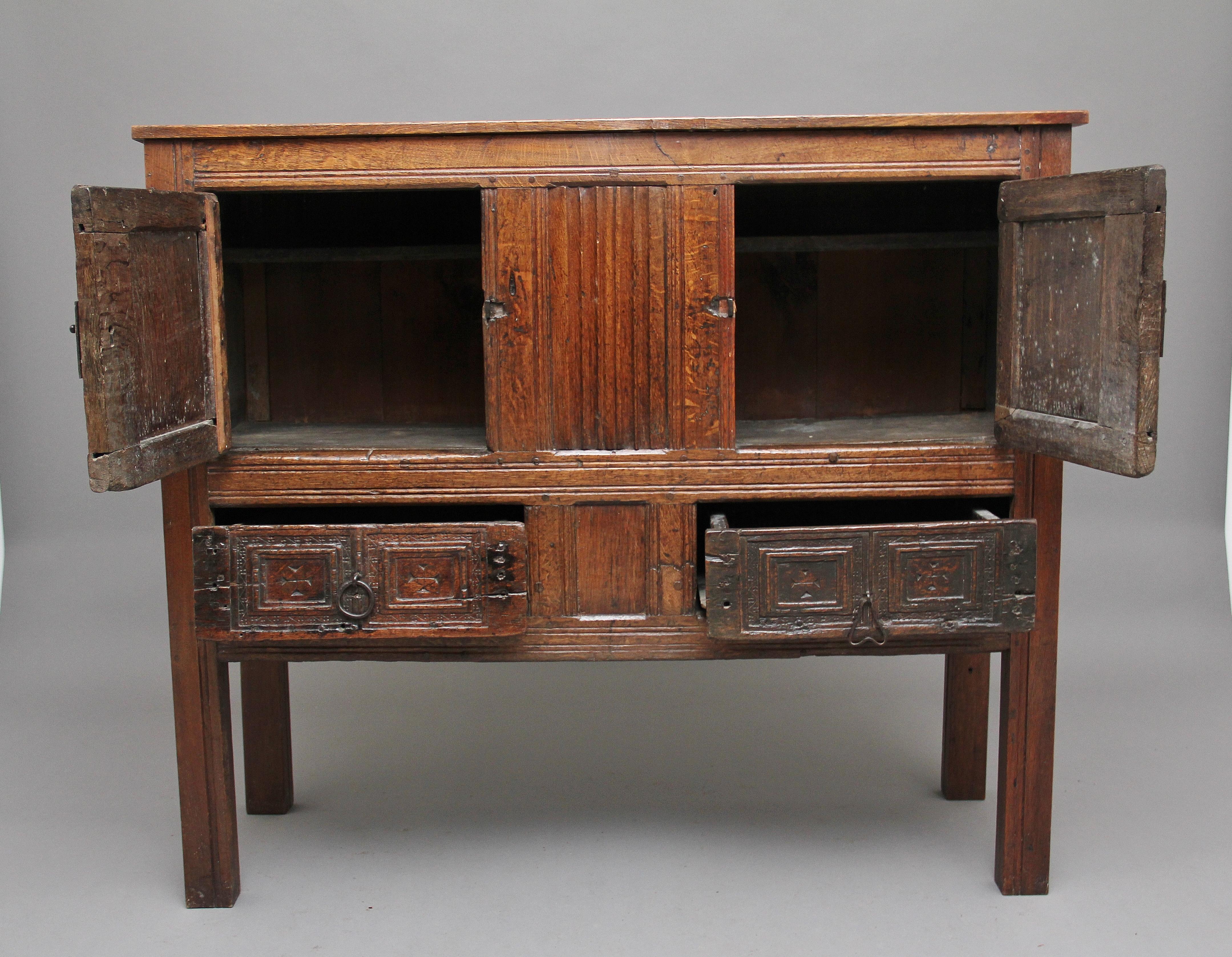 An antique oak aumbry / cupboard, this was more than likely made in part from a 16th Century aumbry, reconstructed in the late 18th century, it has linenfold & chip carving on the front, also iron butterfly hinges and door catches, the cupboard