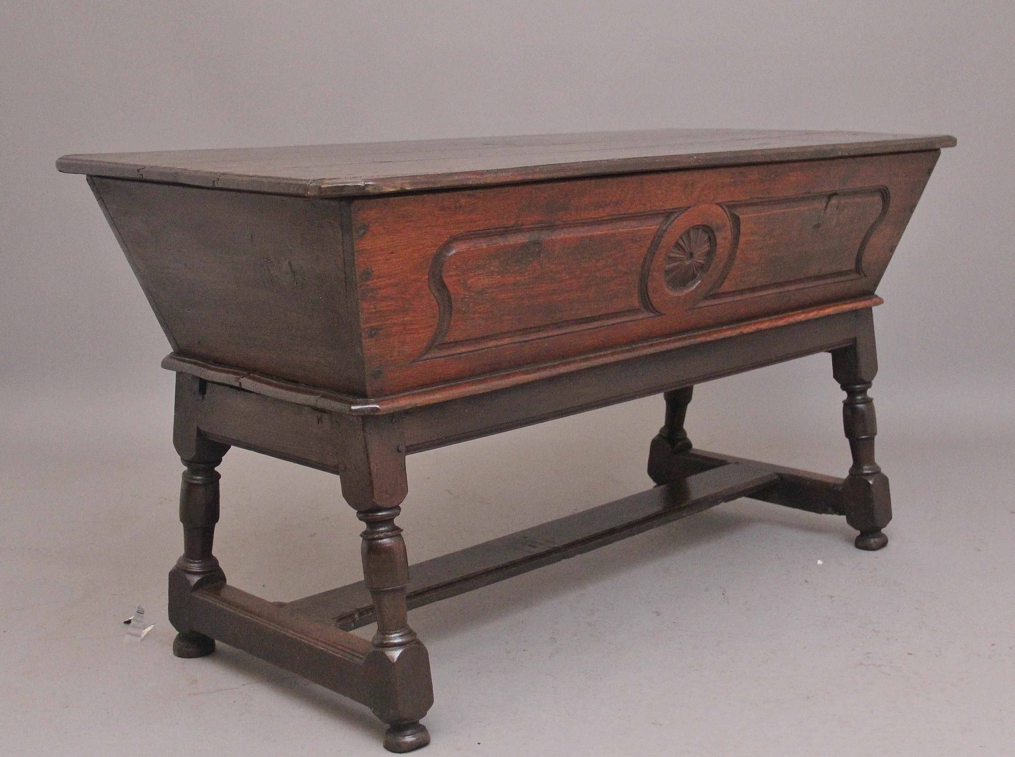 A good quality 18th Century oak dough bin / box on stand, the shaped main body having a lift off lid to reveal a large compartment space which is ideal for storage, with the lid on it can be used as an occasional table, the front of the main body