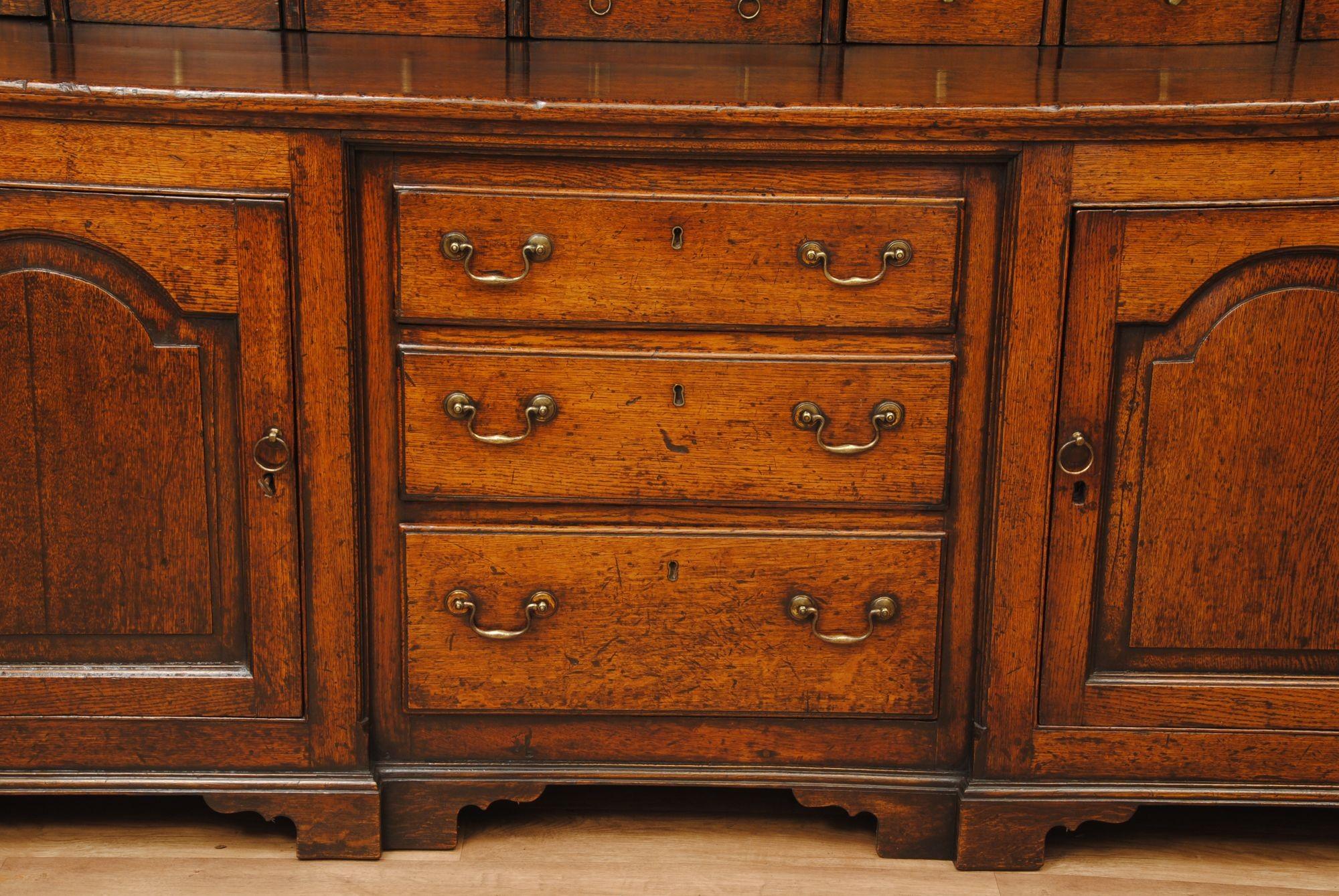 A good example of an 18th century oak dresser with an inverted breakfront section to the base with shaped fielded panels to the doors on either side
The rack with spice drawers and shaped top
Great colour and patination.
Circa 1785
