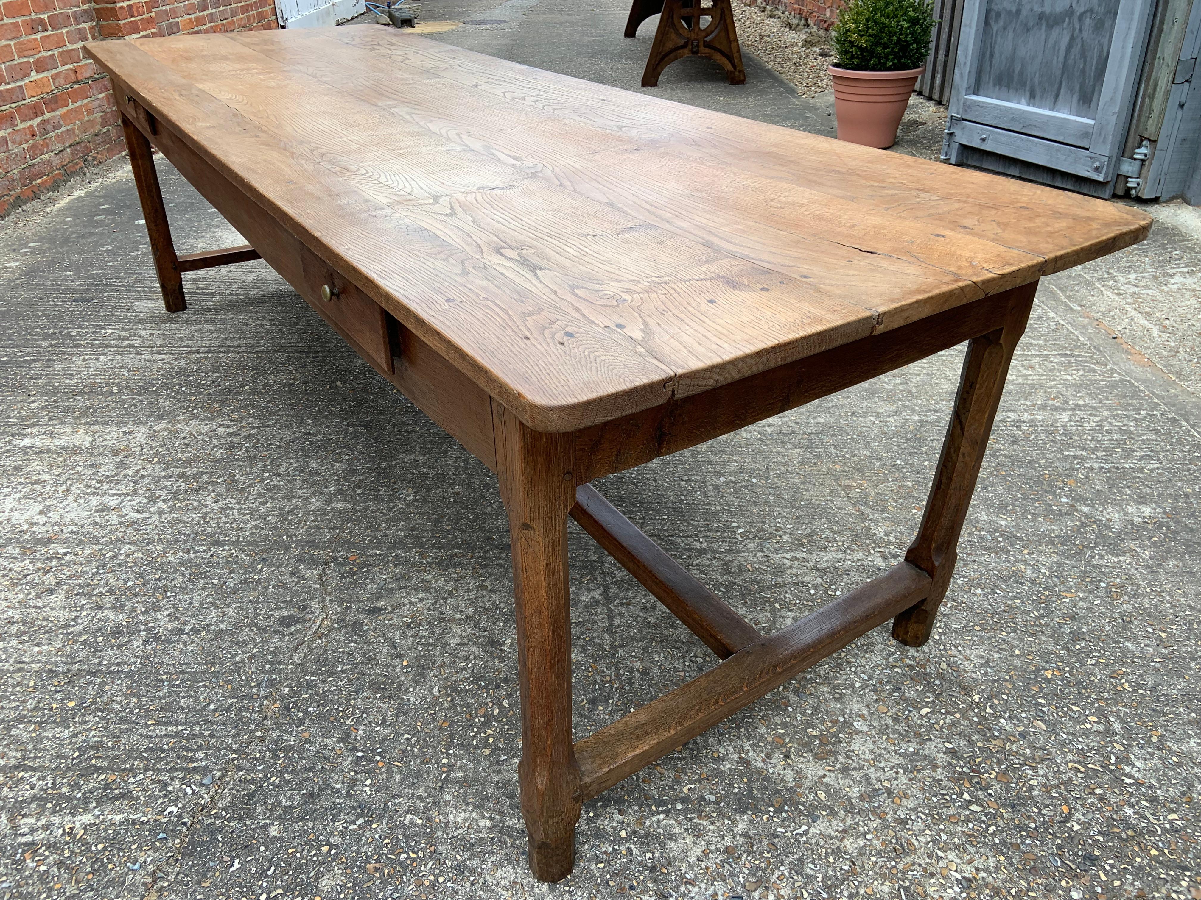 18th century oak farmhouse table with centre stretcher and two side drawers. Beautiful pale coloured top with wide planks and a lot of character. This table has gorgeous patination and stands very well in proportions.
 