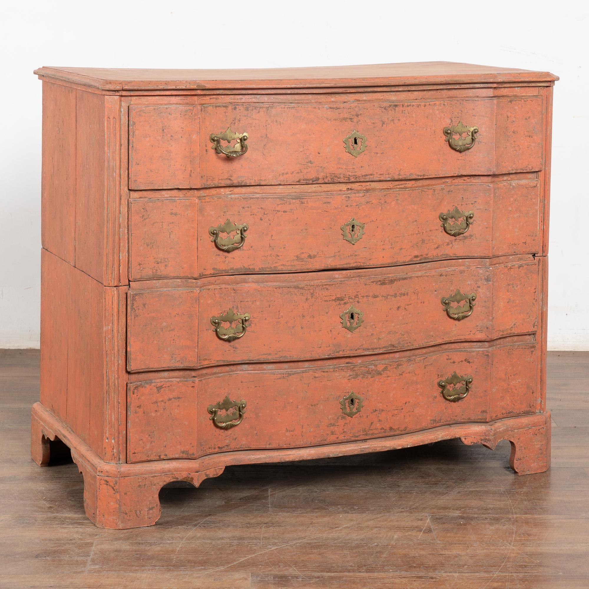This rococo large oak chest of four drawers features a newer, professionally applied and layered salmon painted finish which is gently distressed, revealing the natural wood below while complimenting the age and curved lines of the chest.
This