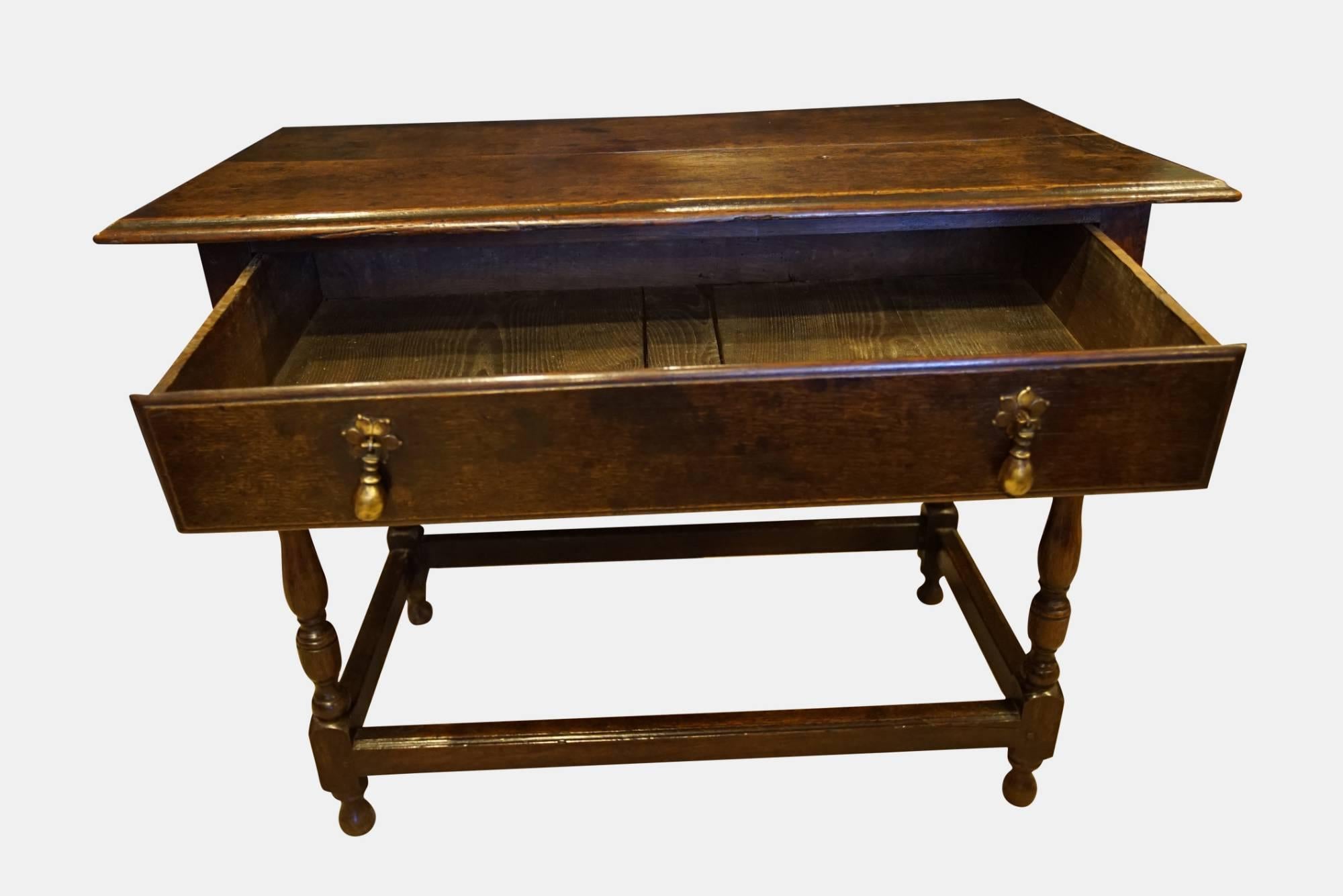 An 18th century oak side table on baluster turned legs and molded stretchers with a single drawer,

circa 1760.