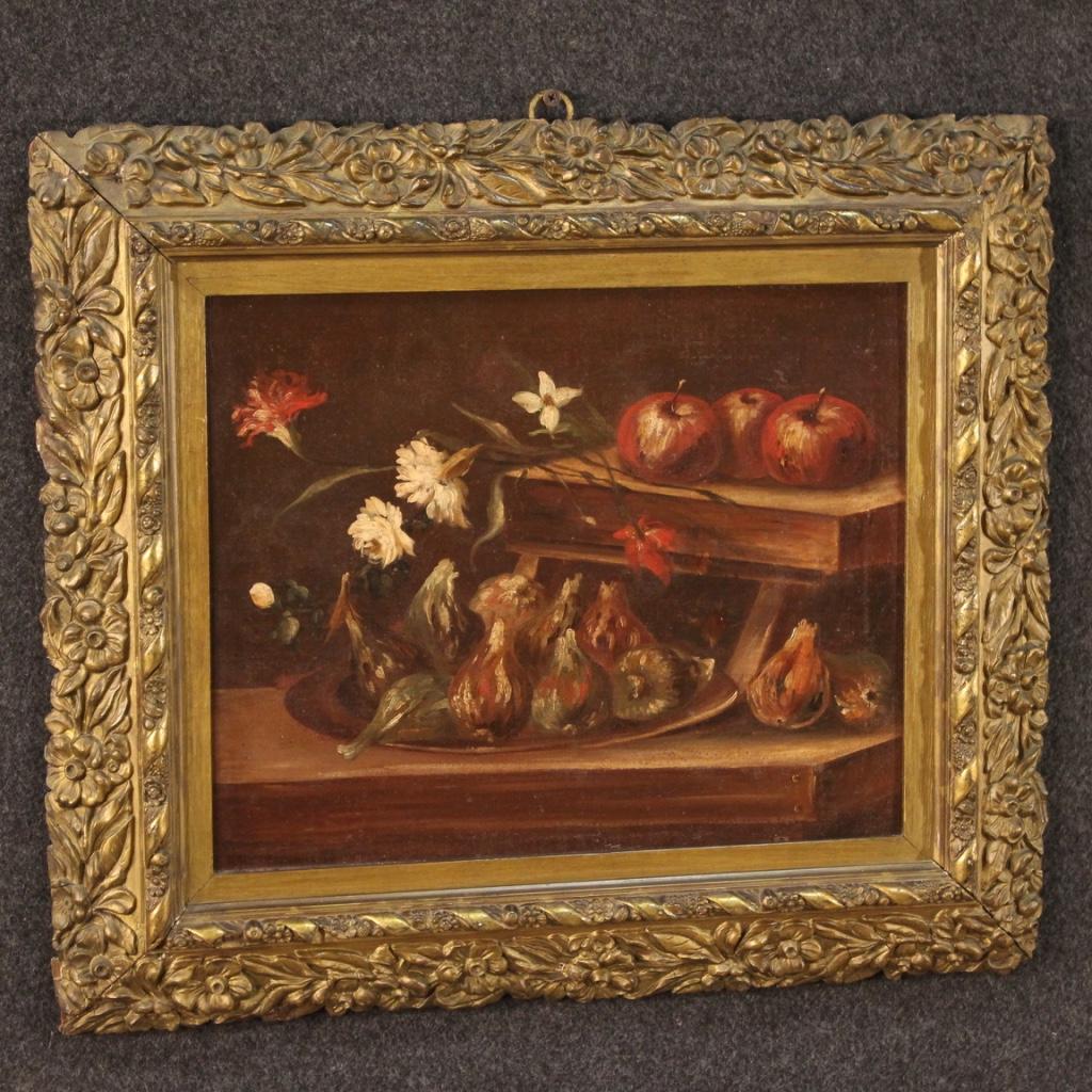 Antique Italian still life from 18th century. Framework oil on canvas depicting a splendid still life with flowers and fruit, with figs in the foreground and apples and floral elements in the background. Frame in wood and plaster, carved and gilded