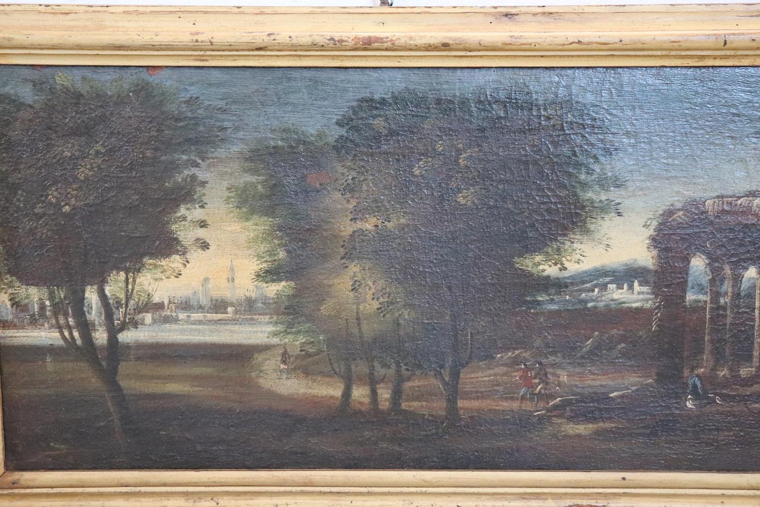 Beautiful antique oil painting on canvas, 1750. A splendid landscape with peaple and architectural elements. Excellent pictorial quality. Sold with antique gilded frame.