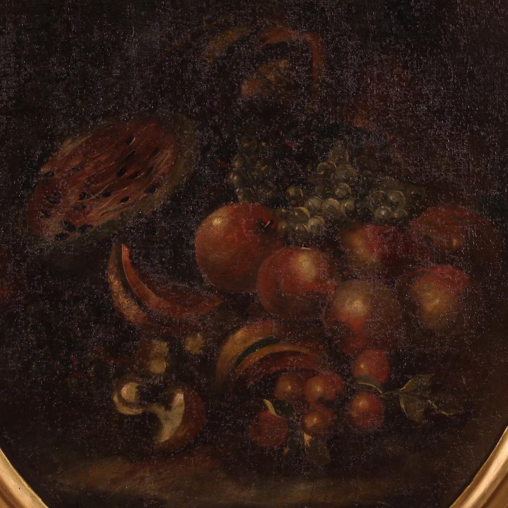 Antique Italian painting from the 18th century. Artwork oil on canvas depicting still life with fruit of good pictorial quality. Oval-shaped painting adorned with a non-Coeval, carved and gilded wooden frame (bronze colour, revived during the 20th