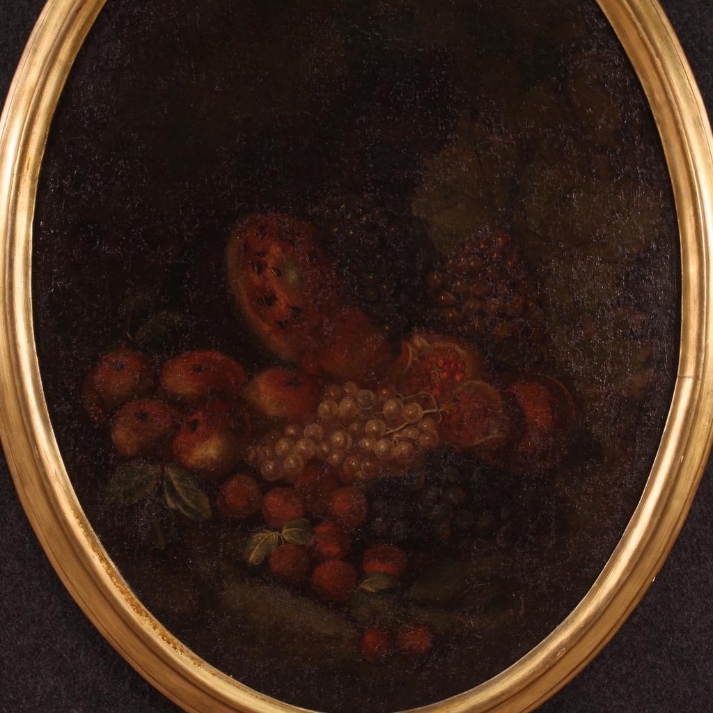 Antique Italian painting from the 18th century. Artwork oil on canvas depicting still life with fruit of good pictorial quality. Oval-shaped painting adorned with a non-coeval, carved and gilded wooden frame (bronze colour, revived during the 20th