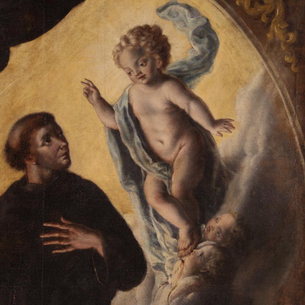 Antique Italian painting from the 18th century. Artwork oil on canvas depicting a religious subject Saint Anthony of Padua and baby Jesus of good pictorial quality. Painting of exceptional size adorned with an antique wooden frame, not coeval,