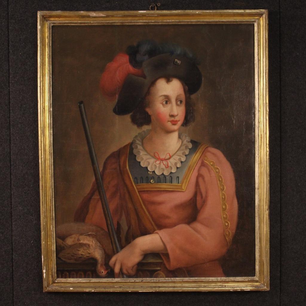 Antique Italian painting from 18th century. Oil painting on canvas depicting a portrait of a young hunter with a rifle and a hunting of excellent pictorial quality. Framework of beautiful measure and pleasant decor with carved and gilded antique