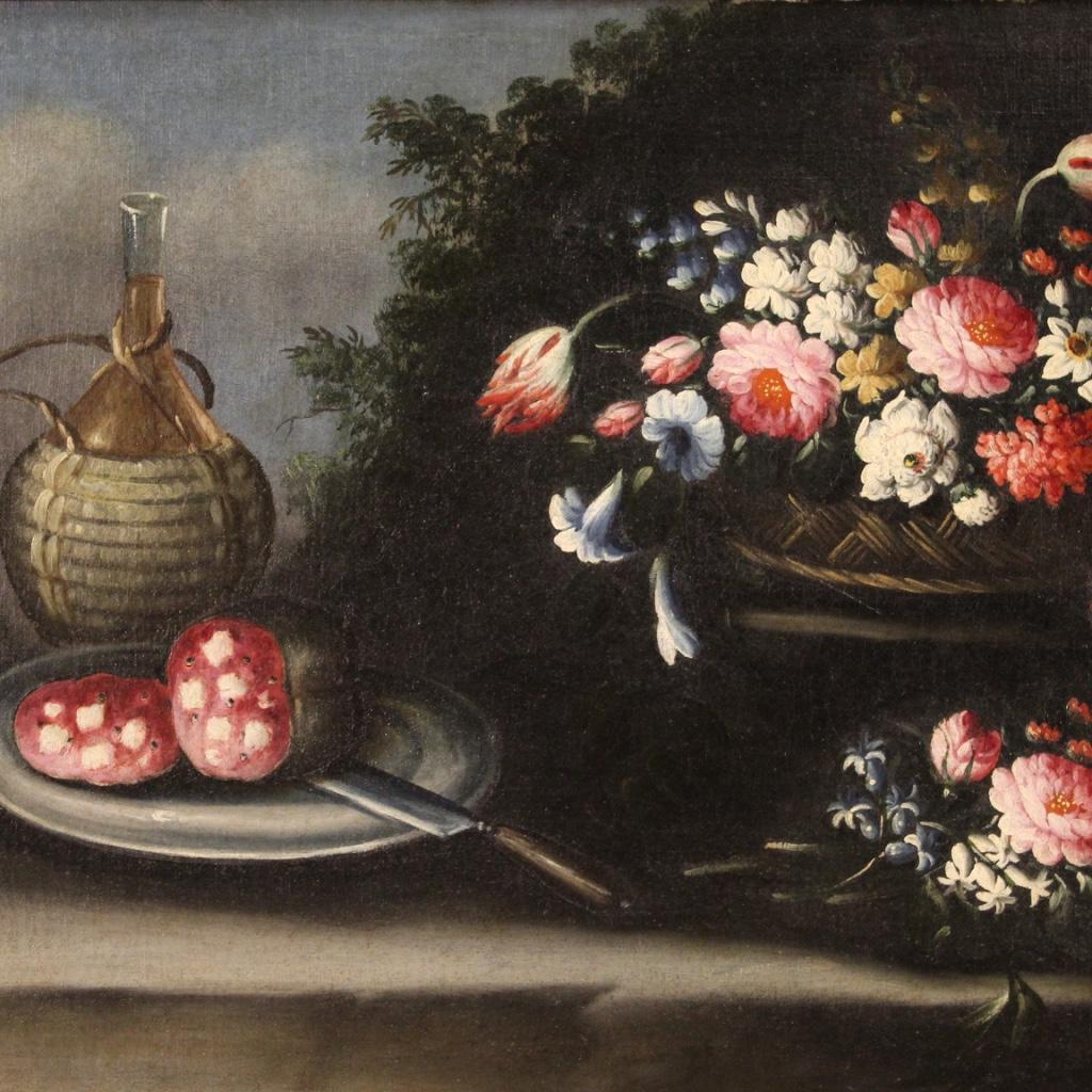 Antique Italian painting from 18th century. Framework oil on canvas depicting still life, Vase with flowers, flask of wine and salami of good pictorial quality. Nice size and pleasantly decorated painting that is part of a pair (see photo and ask