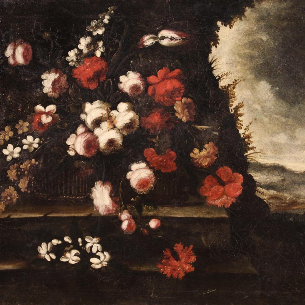 Antique Italian painting from the early 18th century. Artwork oil on canvas depicting a fabulous still life with flowers and a view in the background (right) of excellent pictorial quality. 20th century wooden frame carved, ebonized and gilded of