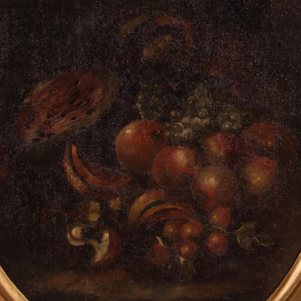 Antique Italian painting from the 18th century. Artwork oil on canvas depicting still life with fruit of good pictorial quality. Oval-shaped painting adorned with a non-coeval, carved and gilded wooden frame (bronze color, revived during the 20th