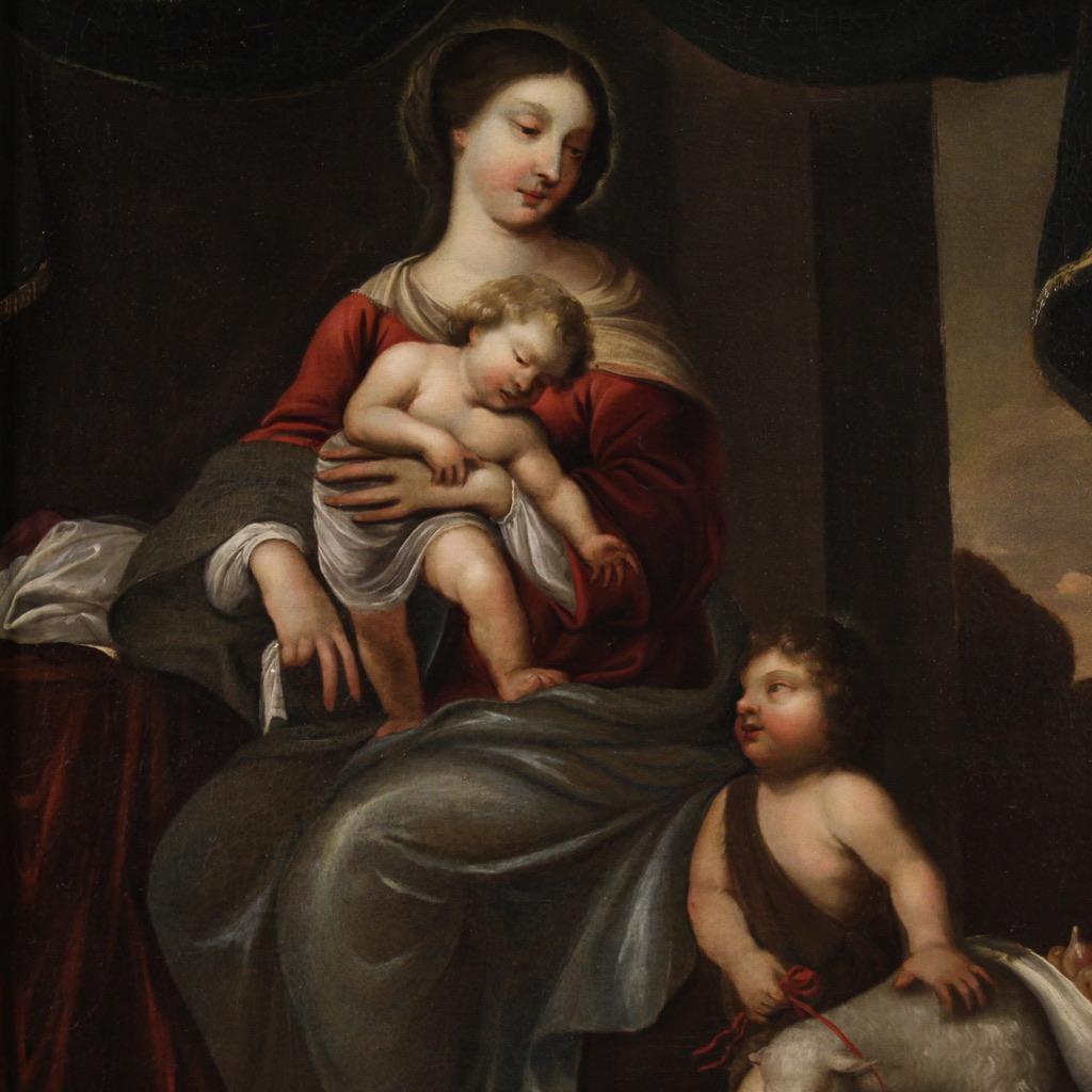 Italian school of the mid-18th century. Painting depicting a splendid Madonna with Child and Saint John, of excellent pictorial quality. The protagonists are represented in a real perspective space, with refined curtains in the background and a