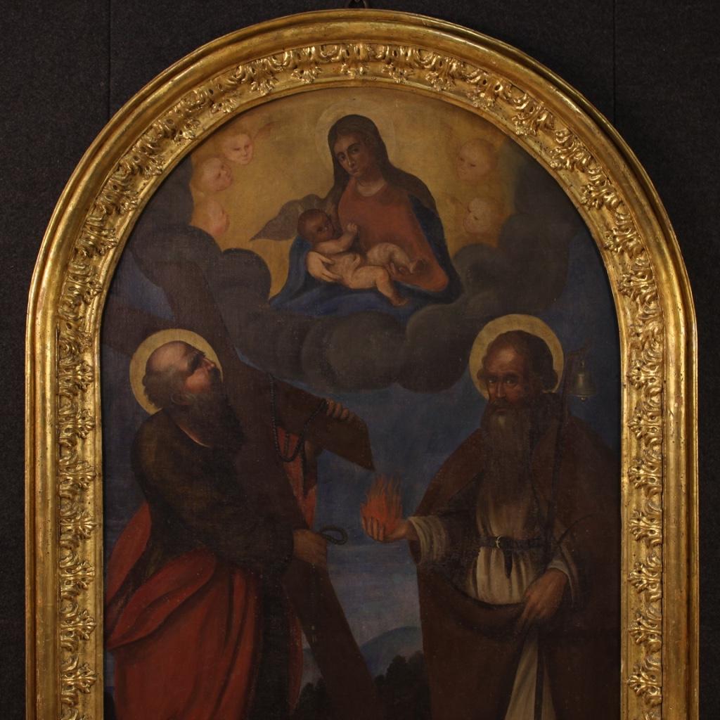 Antique 18th century altarpiece with coeval carved and gilded wooden frame. Italian framework oil on canvas depicting a religious subject, virgin and child with saints, of good pictorial quality. Spectacular antique frame, restored and resumed of