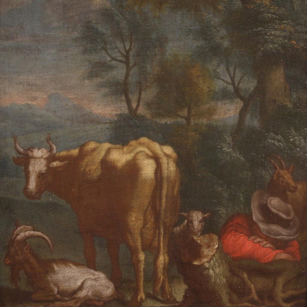 Peinture flamande ancienne du 18e siècle. Cadre à l'huile sur panneau représentant un paysage bucolique avec un berger, une vache et des chèvres, de bonne qualité picturale. Tableau de taille contenue, orné d'un cadre en bois et plâtre, du 19e