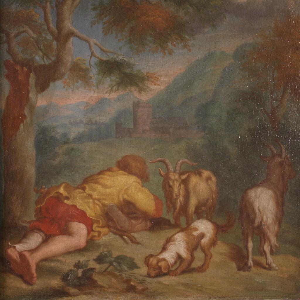 Antique Flemish painting from the 18th century. Framework Oil on panel depicting a bucolic landscape with a shepherd, dog and goats of good pictorial quality. Painting of contained size, adorned with a wooden and plaster frame, from the 19th