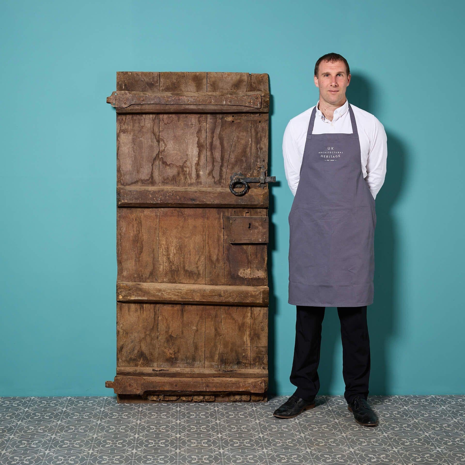 Steeped in history, this early 18th century old English oak plank door is a spectacular heritage feature piece for any interior.

Over 325 years old, this door is a true antique with an ancient air, making a character fixture for a country house