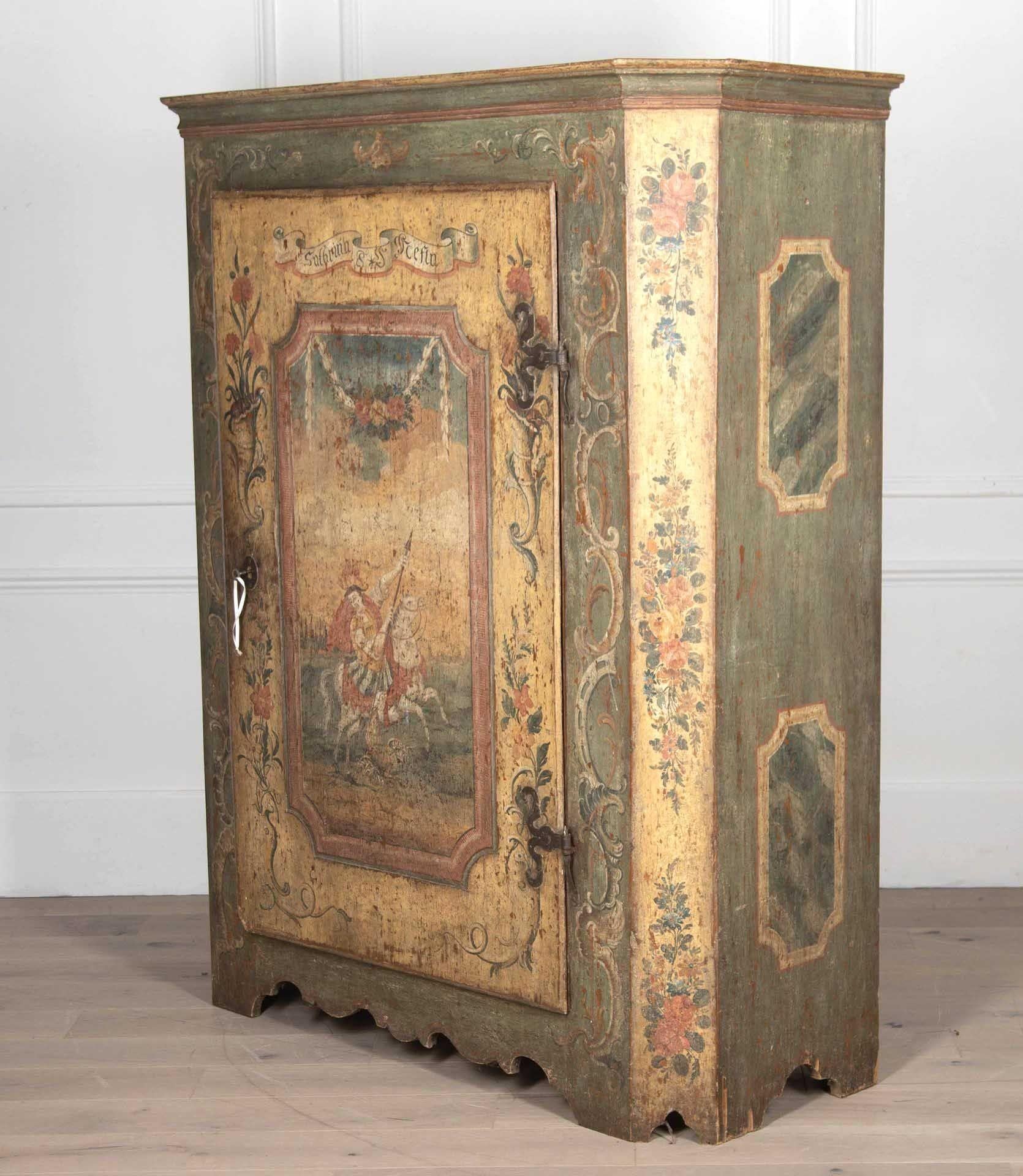 Late 18th Century rare and exceptional example of a painted Tyrolean cupboard.
The single door painted with a scene depicting St George's battle with the dragon framed with profuse scroll and floral decoration. 
Interior is unfitted.
The lock