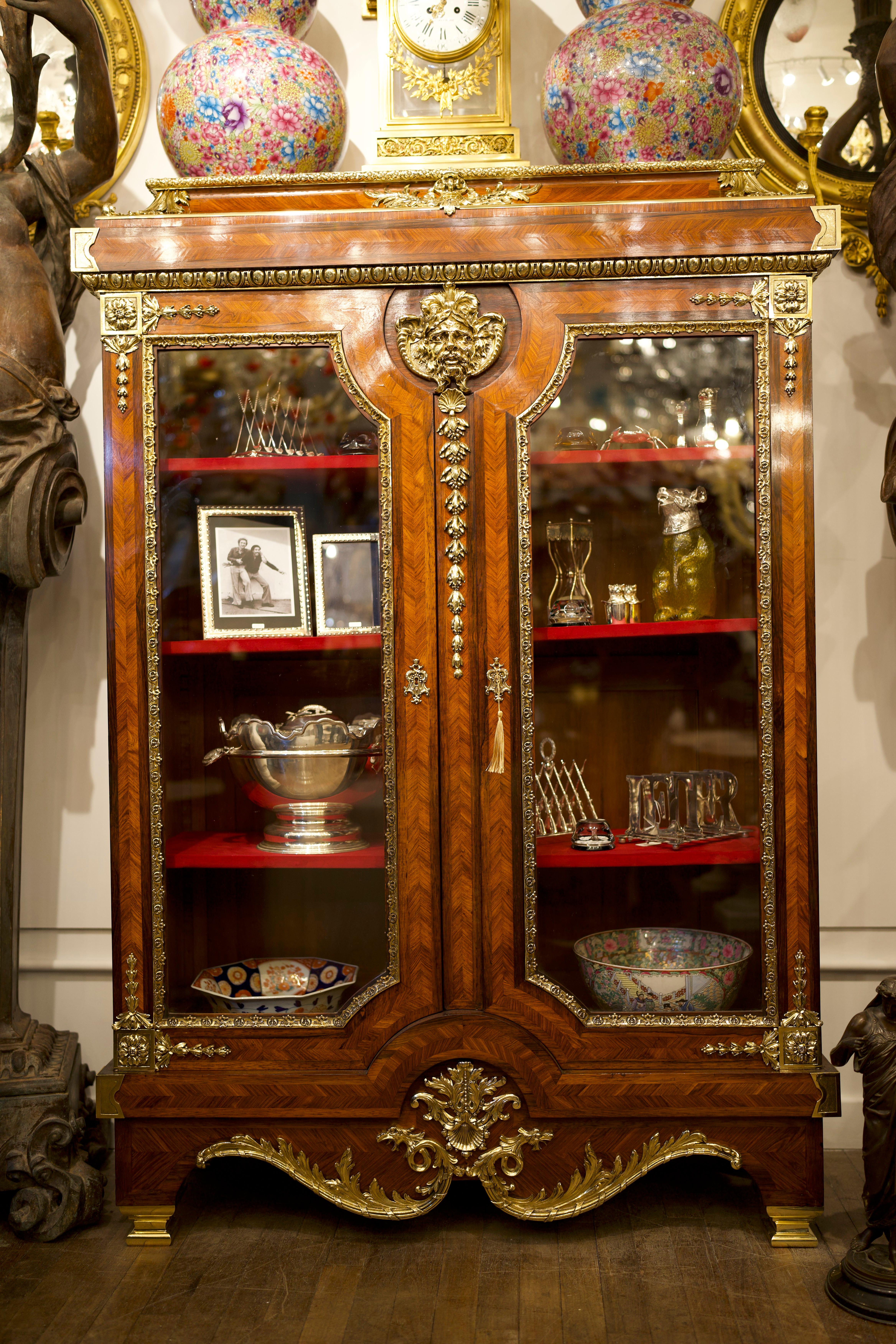 A stunning 18th Century Ormolu Mounted French Kingwood Cabinet/Vitrine.

The cabinet features twin large glazed doors. Each door is finished with Kingwood and separated by inlaid brass banding and set with finely wrought gold gilt mounts. The twin