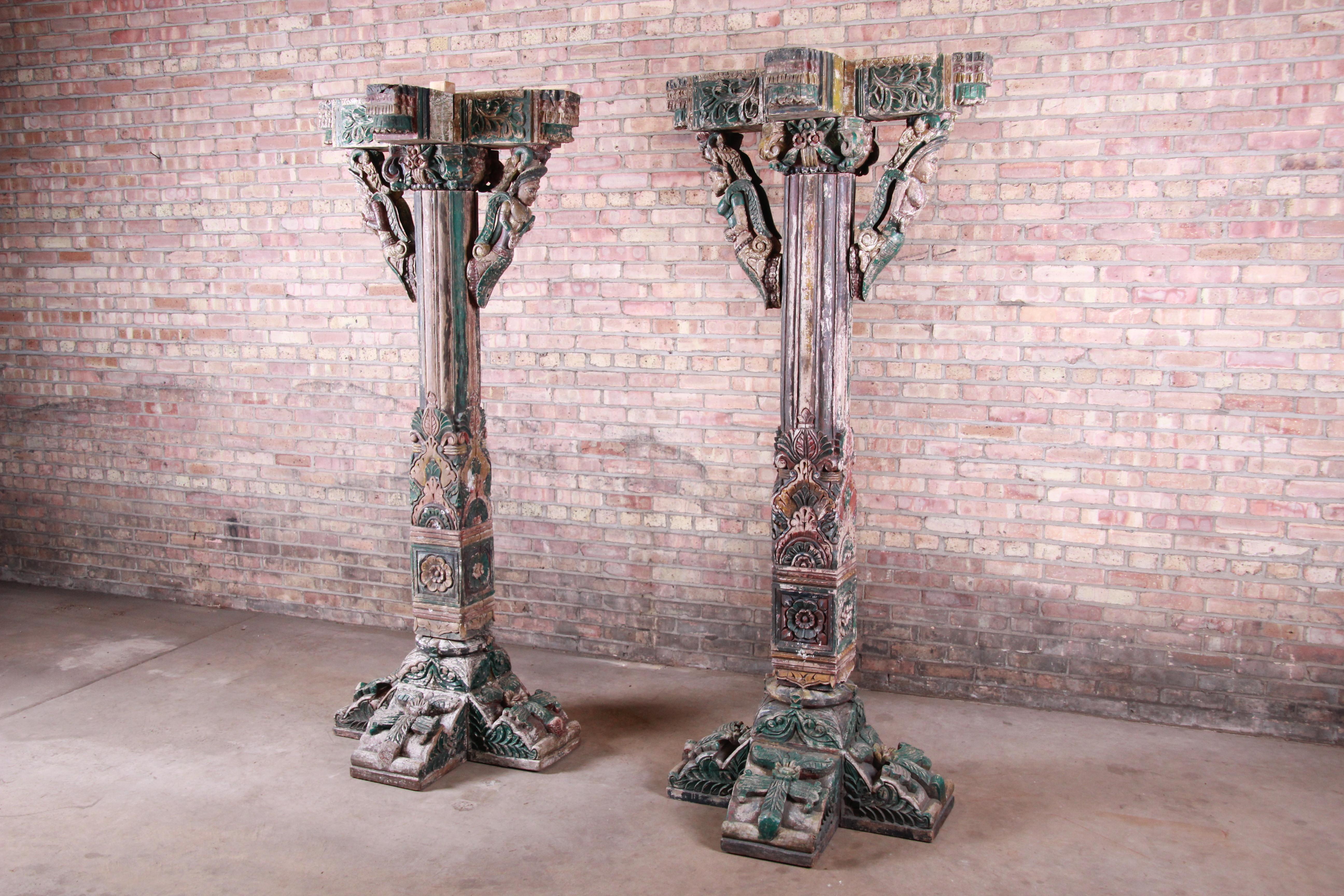 Offering a rare and unique pair of antique handcrafted and painted Indian architectural pillars, made in India, circa late 18th century. The pillars have outstanding carved wood details, as well as the original painted finish with a nice patina from