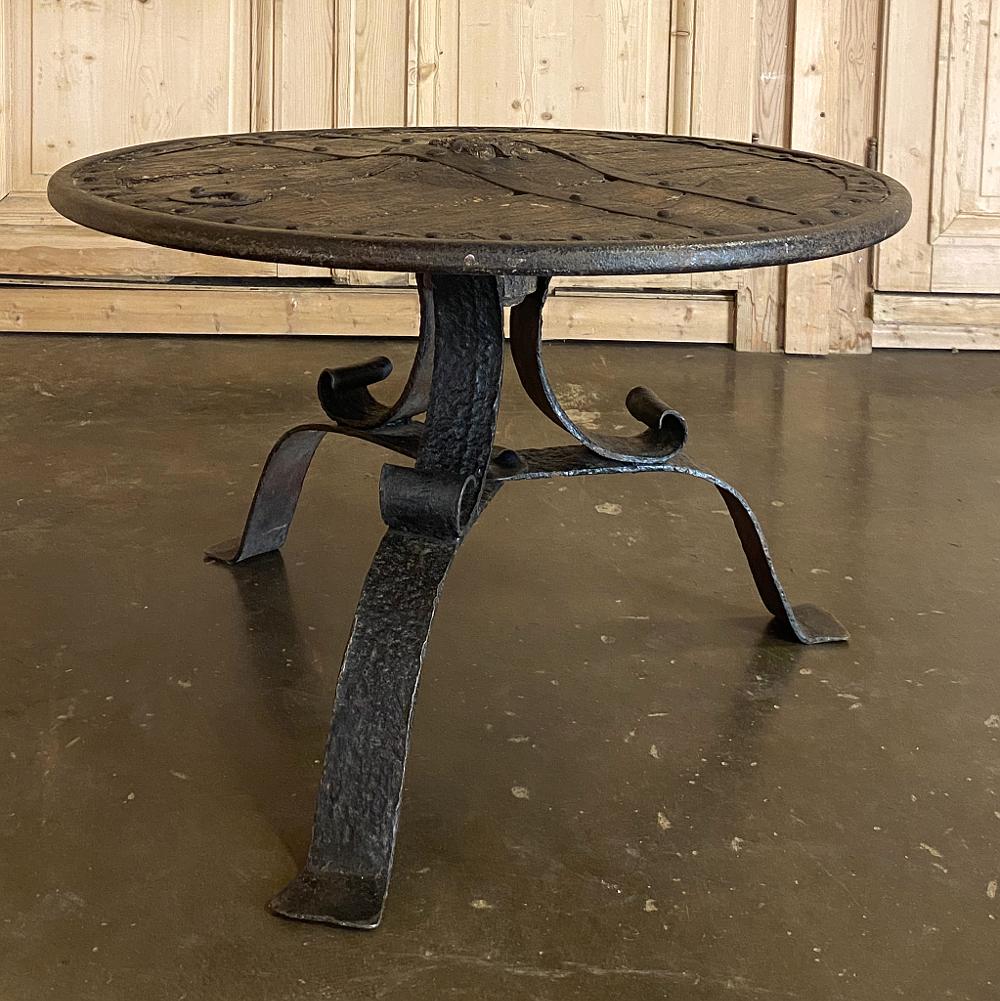 18th century ox cart wheel coffee table represents the ultimate in rustic, southwestern style! Utilizing an ancient ox cart wheel that was handcrafted with what we consider today crude tools out of wood and hand forged iron, the wheel possesses a