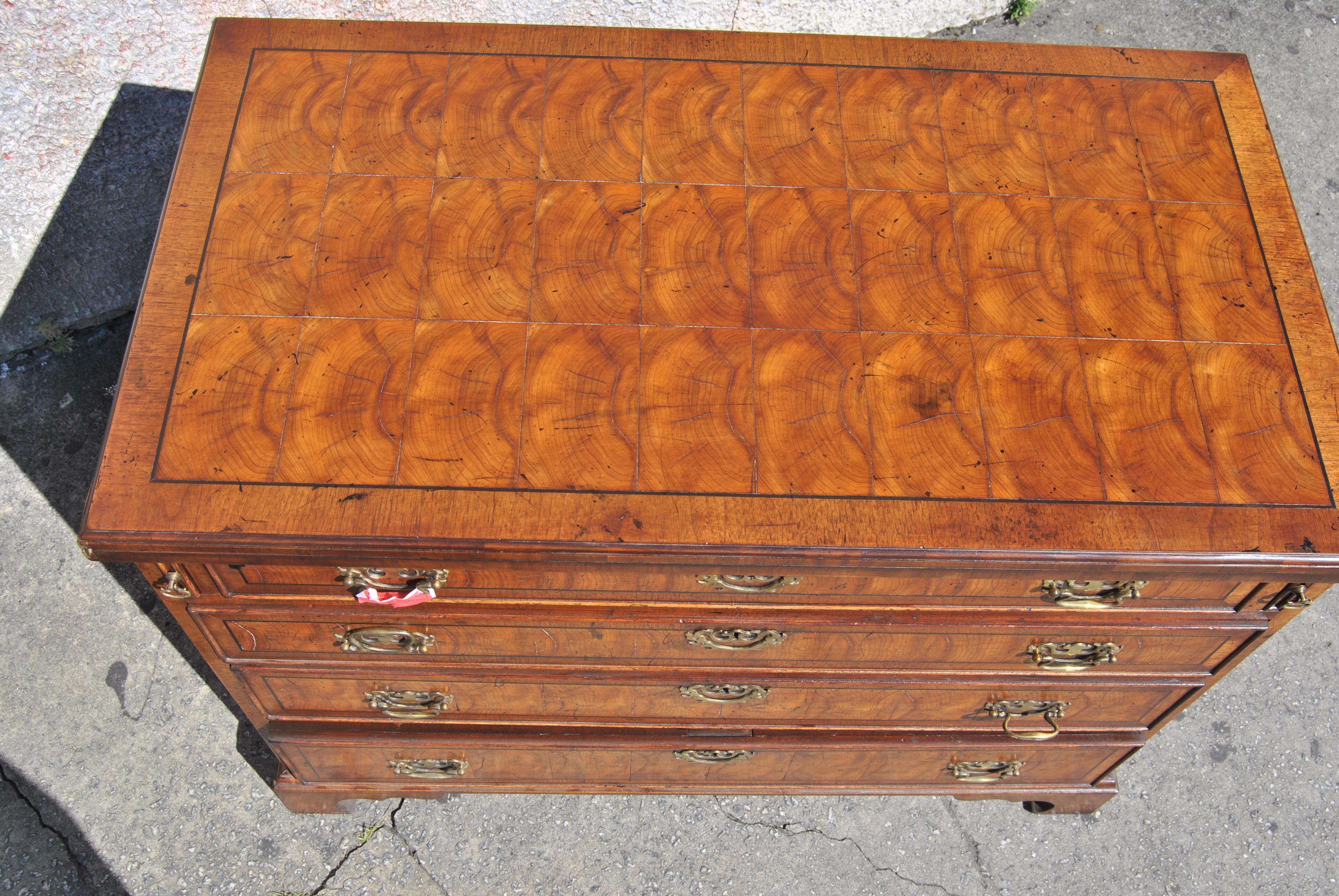 This is a Chest of Drawers, Bachelors Chest, Dresser, made in England, circa 1770. The chest is done in a beautiful Oyster Cut of Walnut. The top has a nicely molded edge. It has a Walnut Banding with a sting inlay of Ebony and Oyster Cuts of Walnut