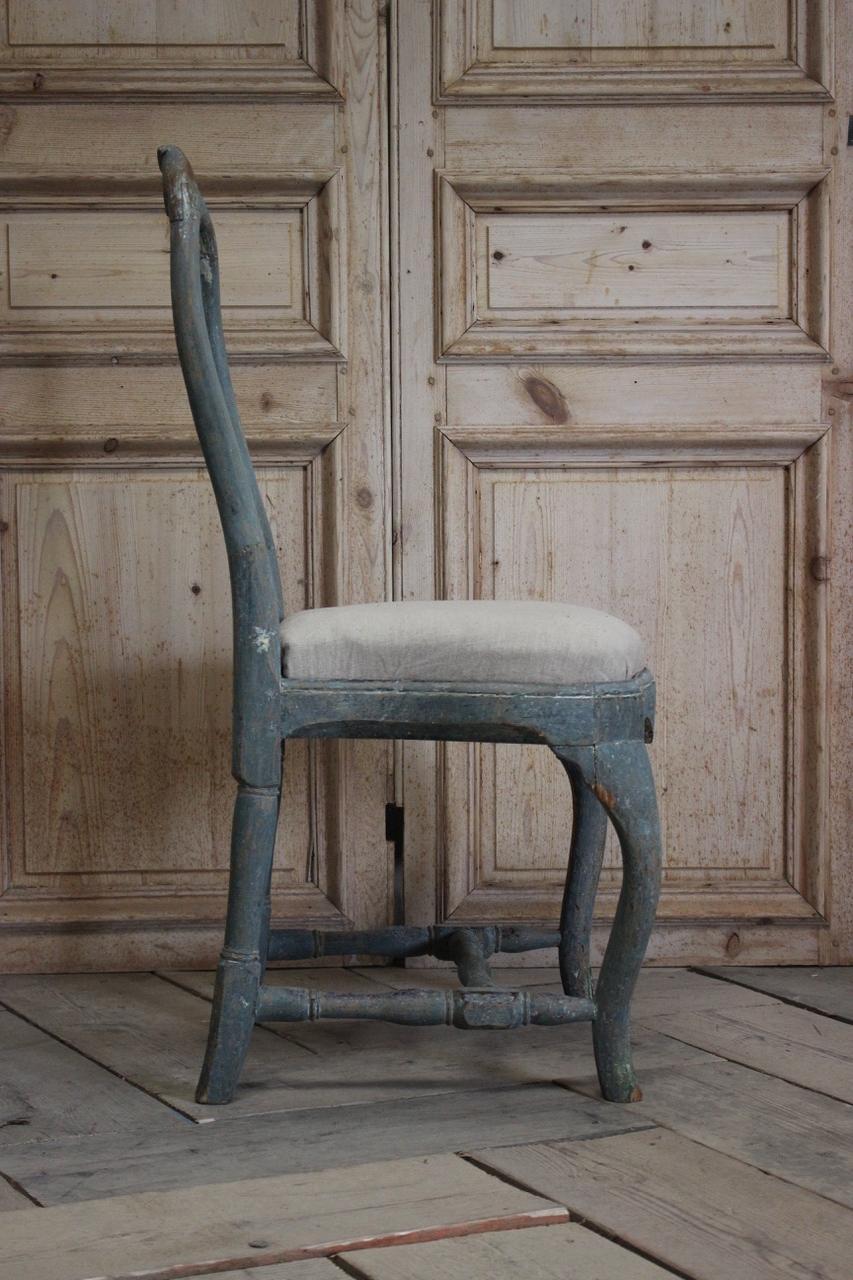 A very elegant and retaining the original blue paint, 18th century Swedish Rococo chair, with a lovely color.