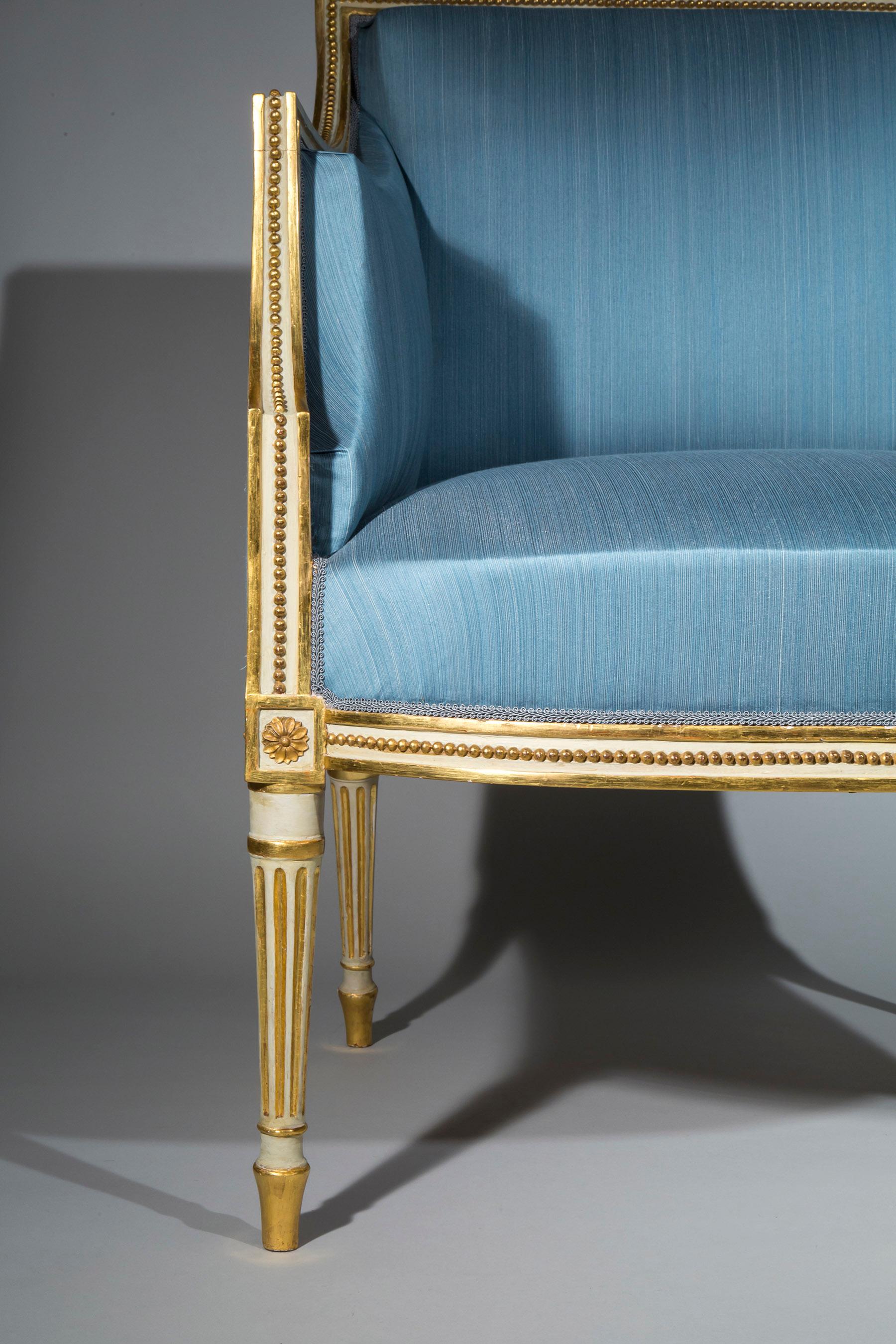 An exceptional George III period pair of cream-japanned and parcel-gilt armchairs, in the manner of Francois Hervé.

English, circa 1790.

A related pair of George III painted and parcel-gilt open armchairs, similarly decorated in the manner