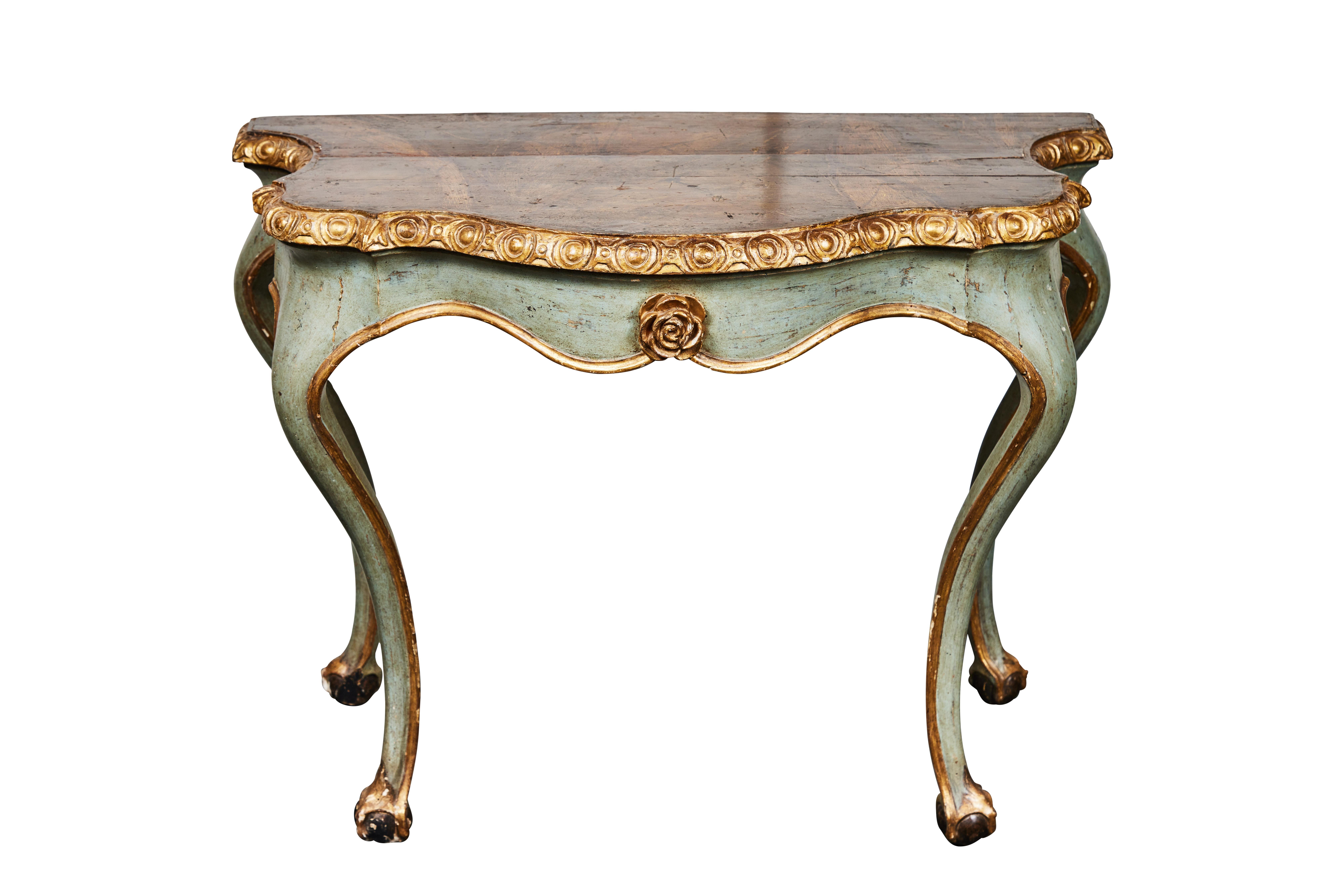 A remarkable pair of hand carved and painted, Italian, serpentine demilunes on unique, webbed claw and ball feet. The faux marble top sits above fine, 22-karat giltwood trim. Each piece is centered with a beautifully relief-carved and gilded rose in