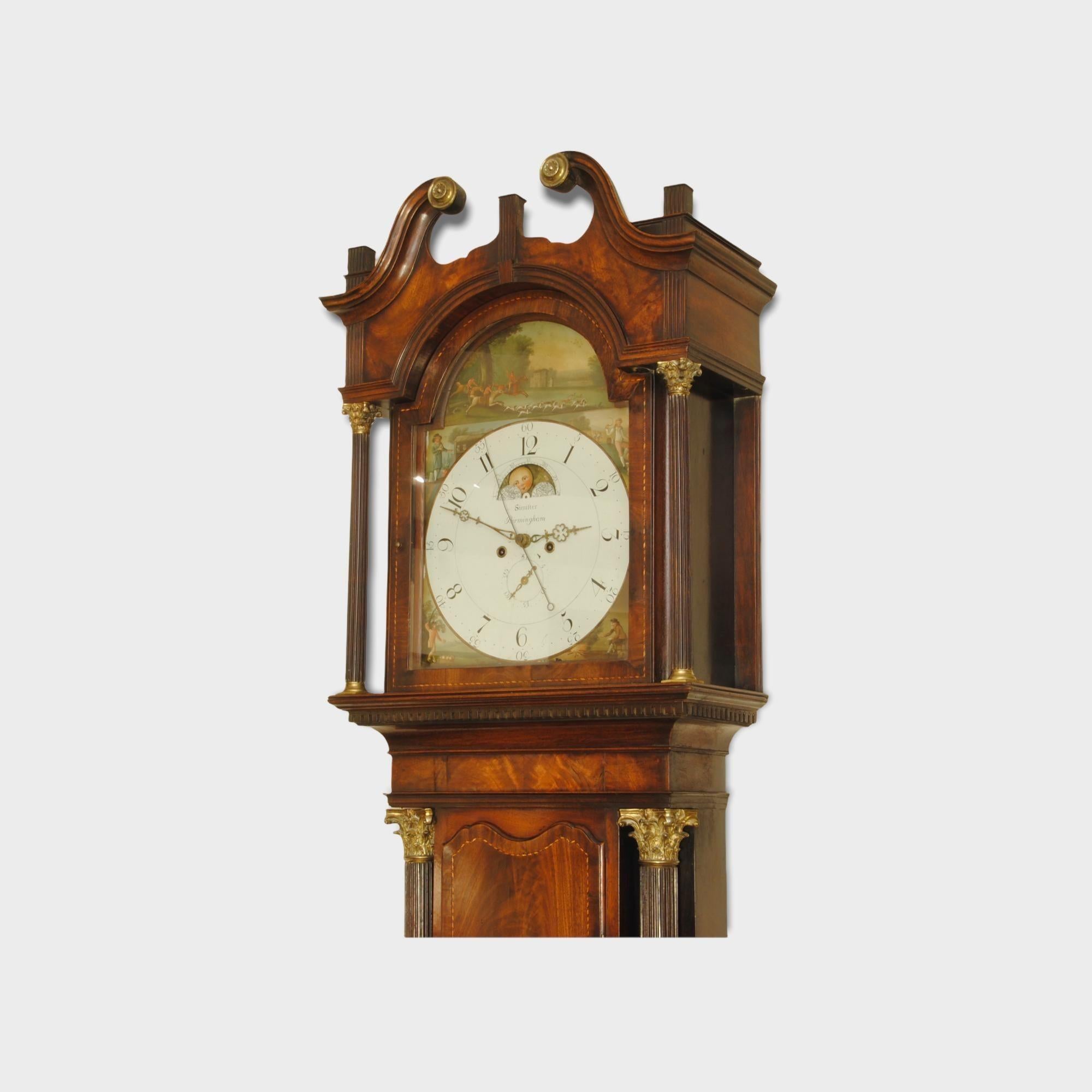 An imposing 18th century eight day long case clock by Simister of Birmingham. The amazing mahogany case has a flame mahogany veneered door and the large reeded columns with ormolu mounts to the top. The whole case inlaid with bandings and stringing.