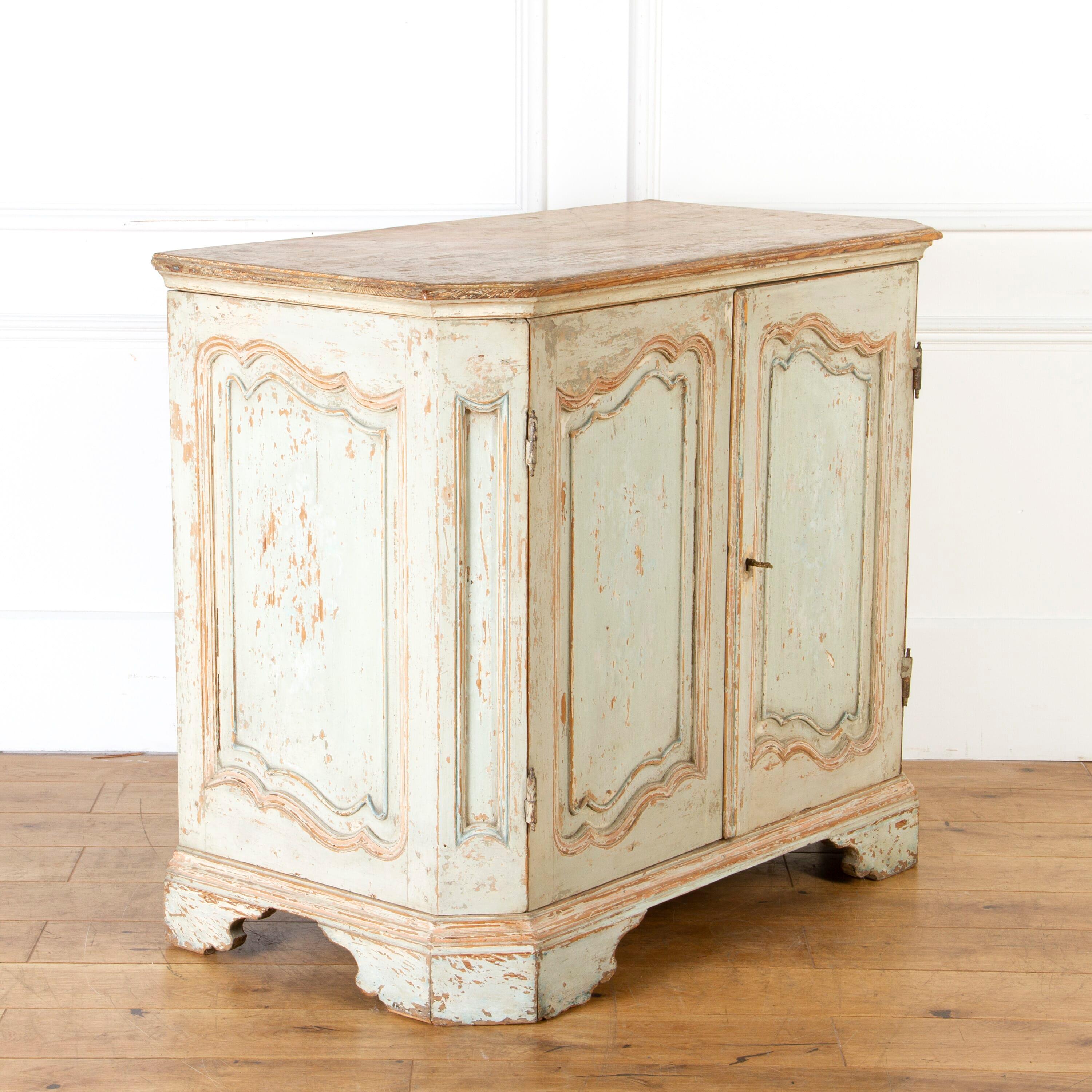 French 18th Century two-door buffet.

This attractive piece has its original hardware and early paintwork.

It has two panelled doors that open to a spacious interior and two deep-set shelves.

The whole is raised on a beautifully carved apron, with