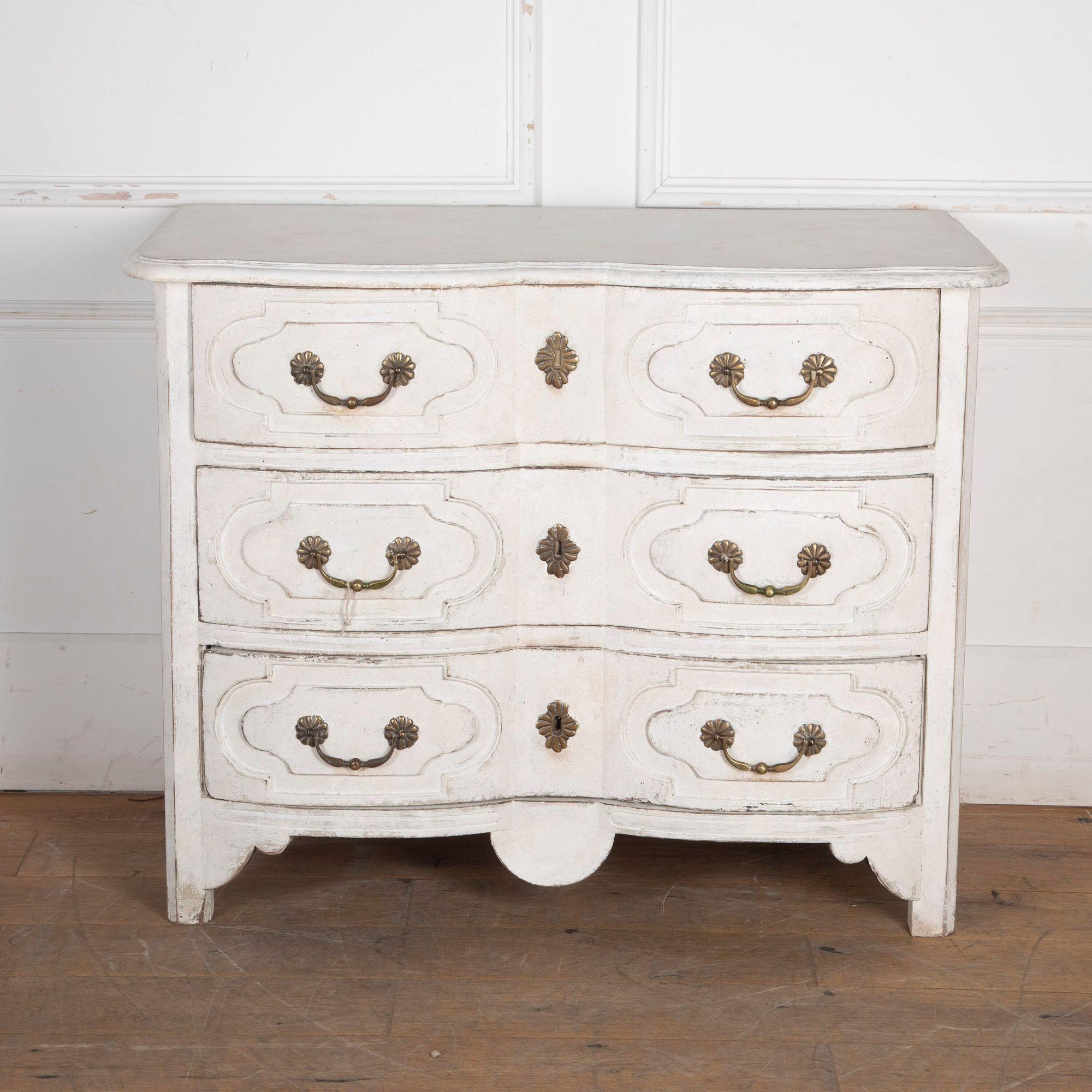 Handsome 18th Century French serpentine front commode. 
With carved details on the drawers and paneled sides.
Retaining its original hardware, including flower motif fastenings to the handles. Recently repainted.