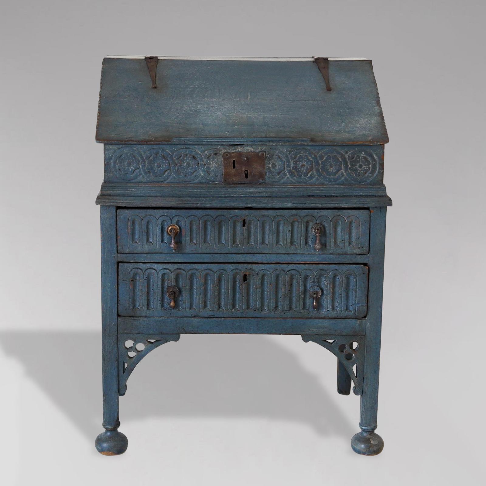 A wonderful characterful late 18th century portable painted carved oak bureau or bible box on a stand. There is carved detail throughout, in a mainly floral style with some reeded ornate shaped carvings to the base. The top with moulded edge and