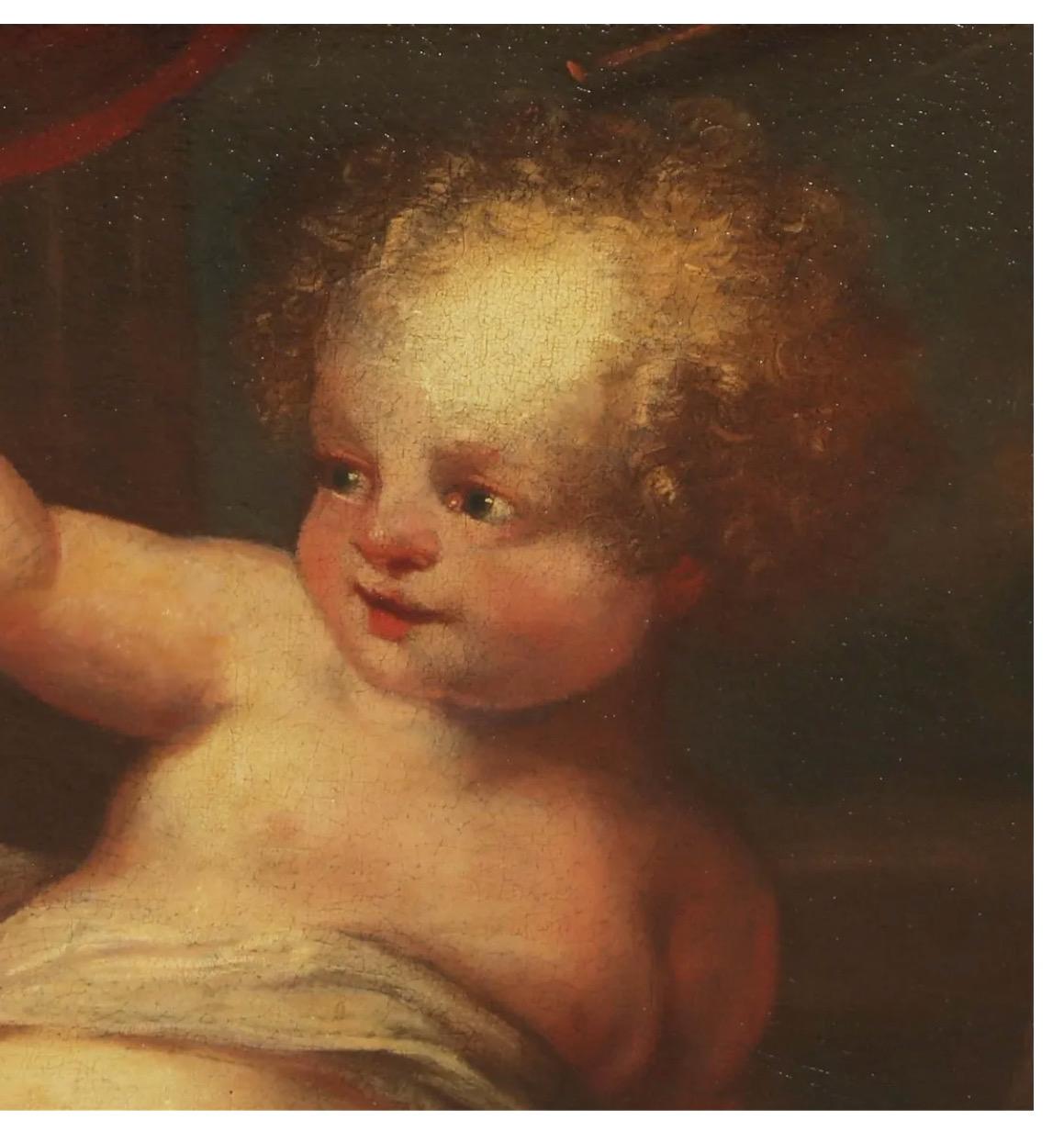 This is a charming painting of a cherub with an arm extending forward, perhaps hold out a bouquet of flowers. The painting dates to the mid-18th century and is probably cut from a larger painting. The putti is well-framed in a French a gold leafed