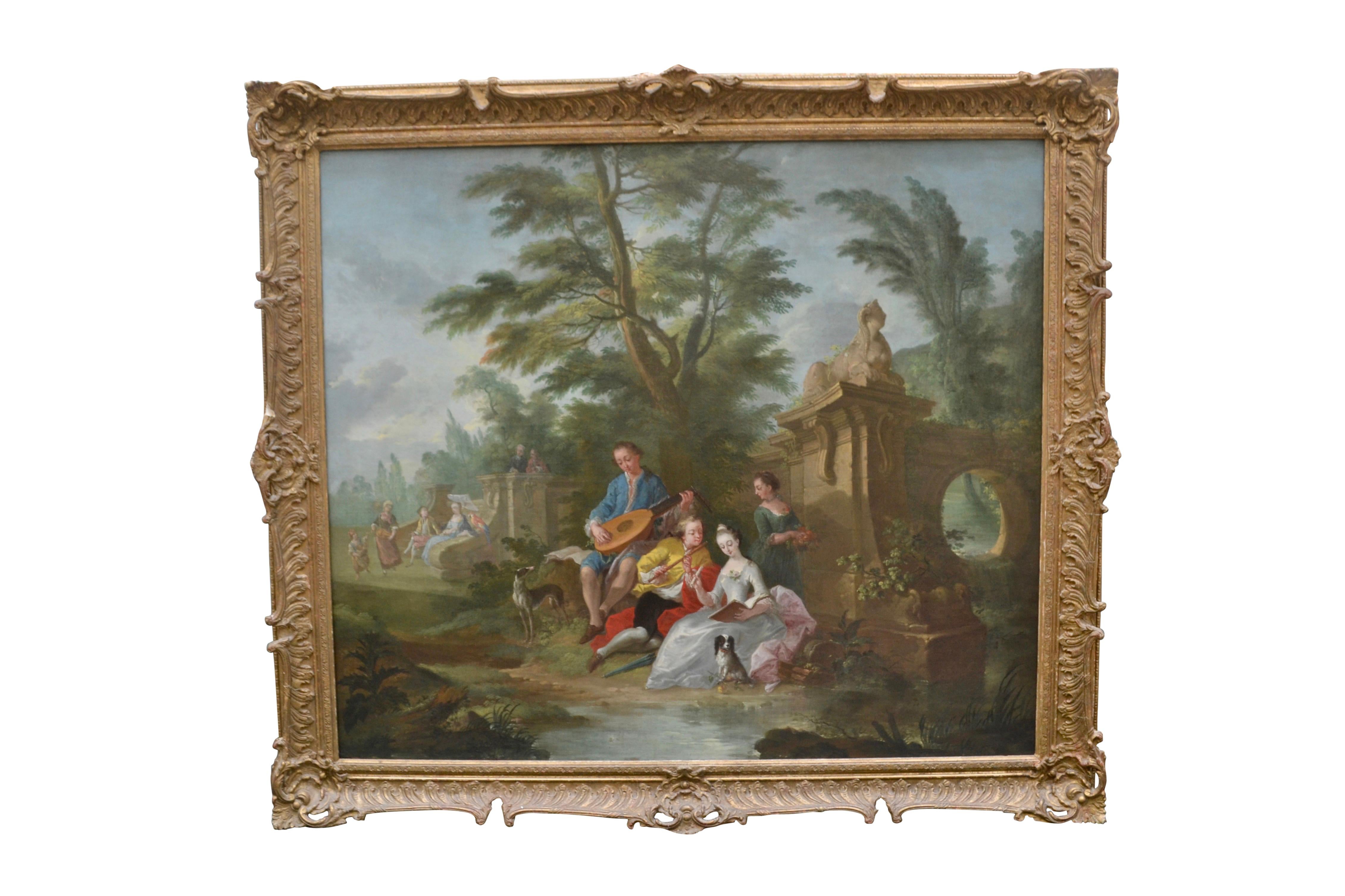 A romantic 18th century oil painting on canvas depicting two young couples in an idyllic landscape, the figures sitting by a stream beside a garden folly, their pets with them. The two men serenade the women with their stringed instruments. The