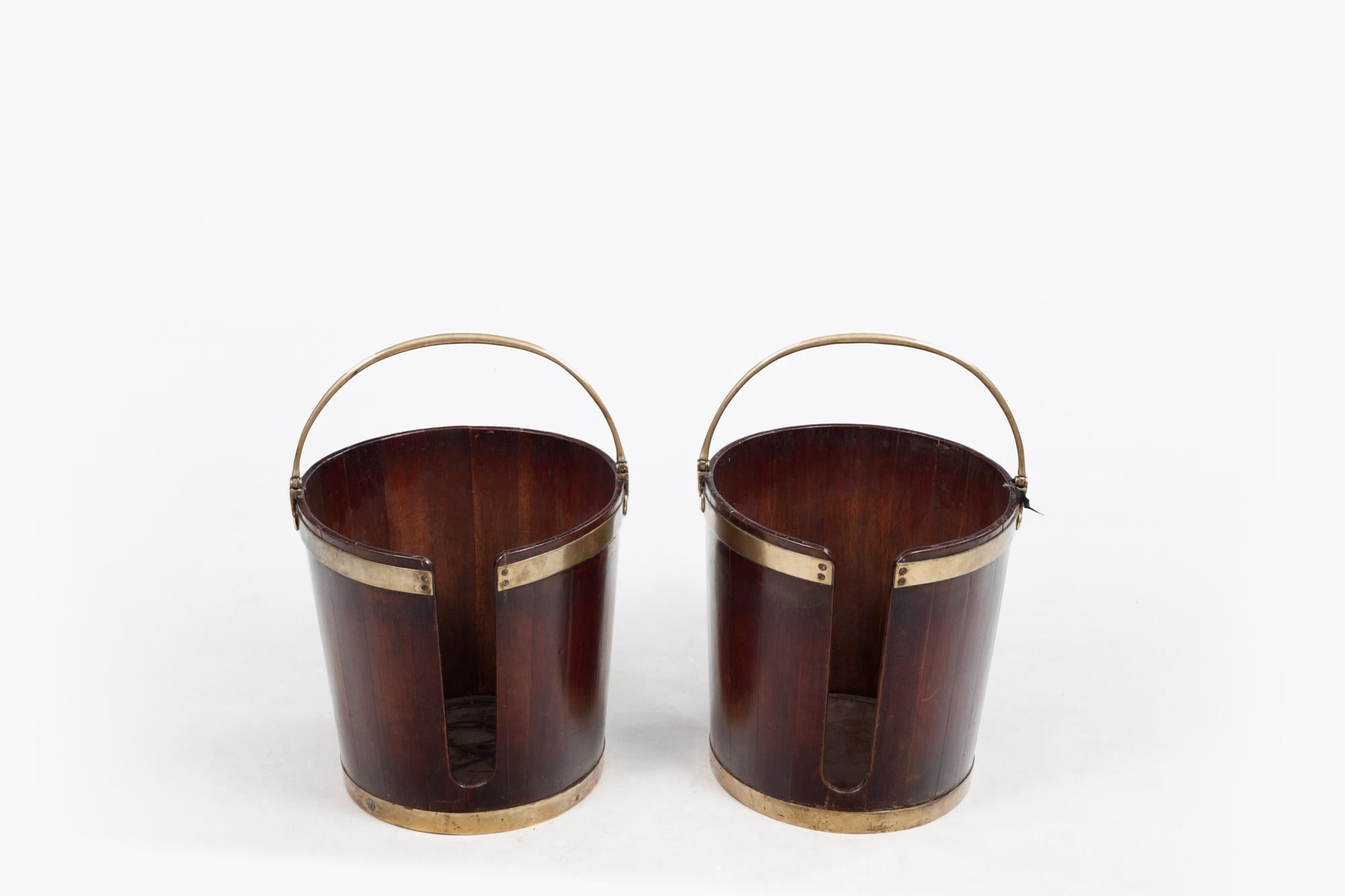 18th Century pair George III mahogany and brass bound plate buckets of coopered construction, with two brass bands and brass swing handle. Circa 1770.