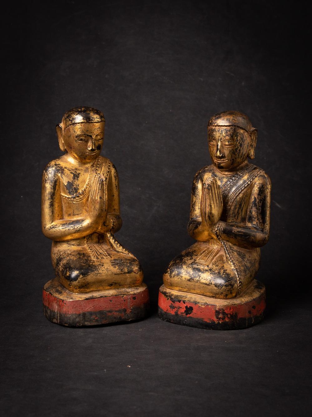 The pair of antique wooden Burmese Monk statues is a remarkable and spiritually significant artifact originating from Burma. Crafted from wood and gilded with 24-karat gold, each statue stands at 25 cm in height and measures 12.3 cm in width and