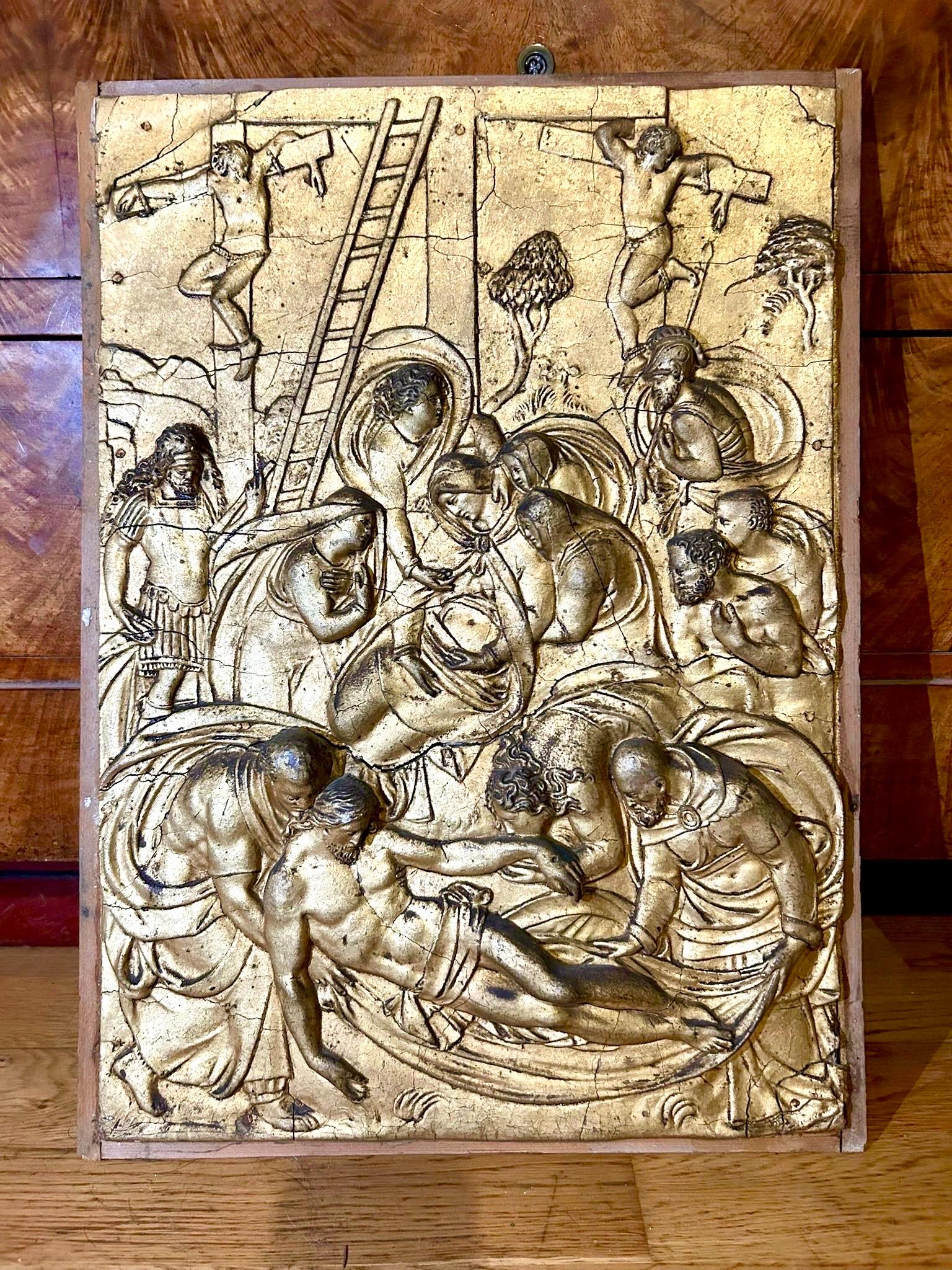 This rare pair of gilded stucco panels on wood, created in the late 18th century, depicts two major scenes from the New Testament: The Deposition from the Cross and The Adoration of the Magi. Finely carved in bas-relief, these works demonstrate