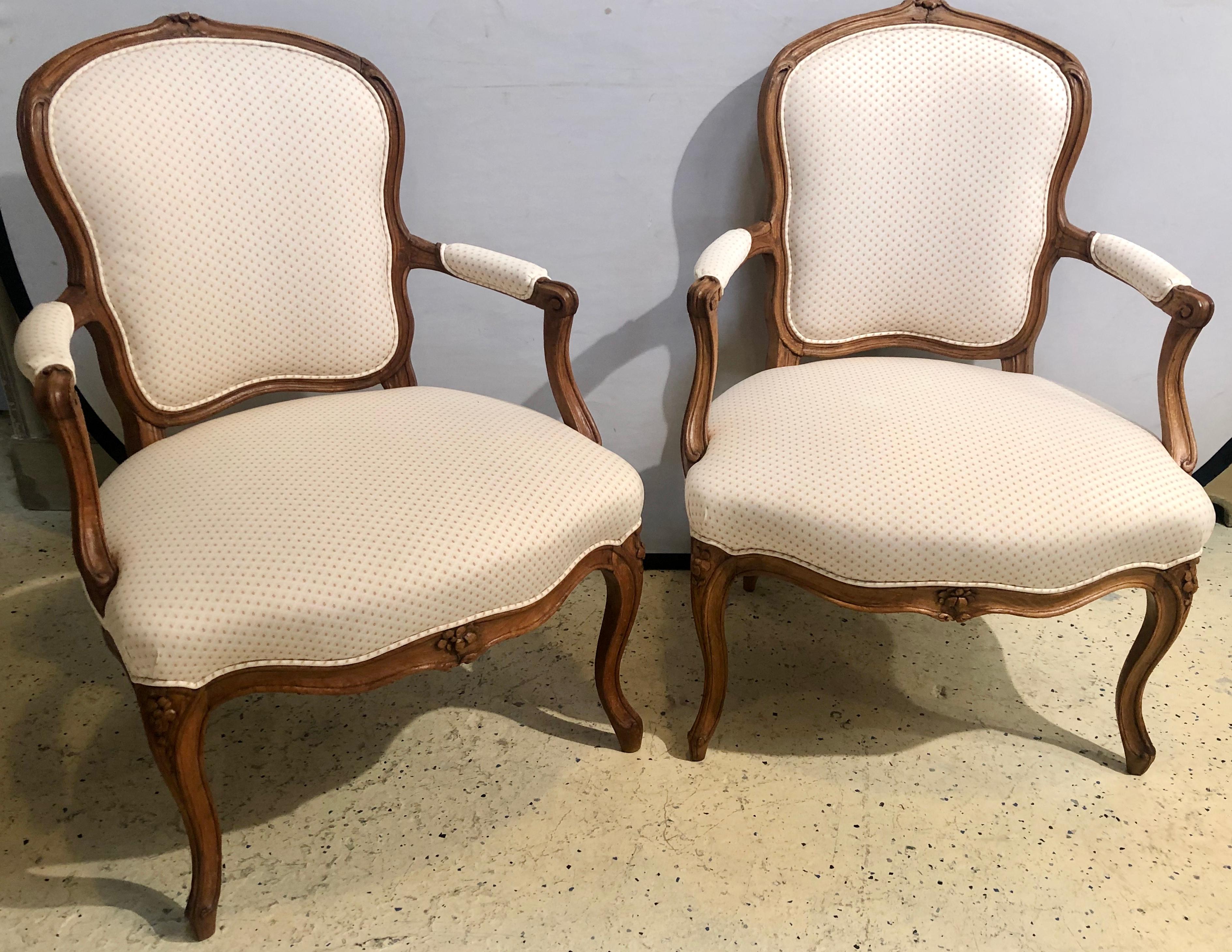 18th century pair of beechwood fauteuils or armchairs with provenance. There are a total of four of these finely carved and upholstered fauteuils or arm chairs available. This listing is for one pair only. Each in fine strong sturdy condition with