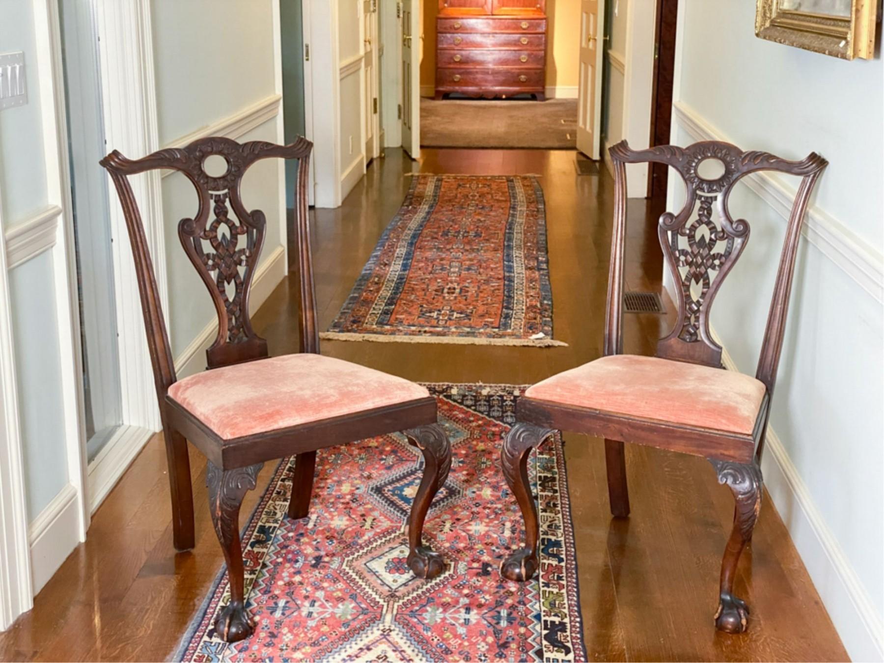 A pair of Chippendale carved Walnut side chairs, with pierced and shell carved and scroll eared crest rail, rare tassel and rope motif carved splat, shell carved knees, and ball and claw feet. 
Measures: 39 X 23 1/4 X 19 1/4 inches.