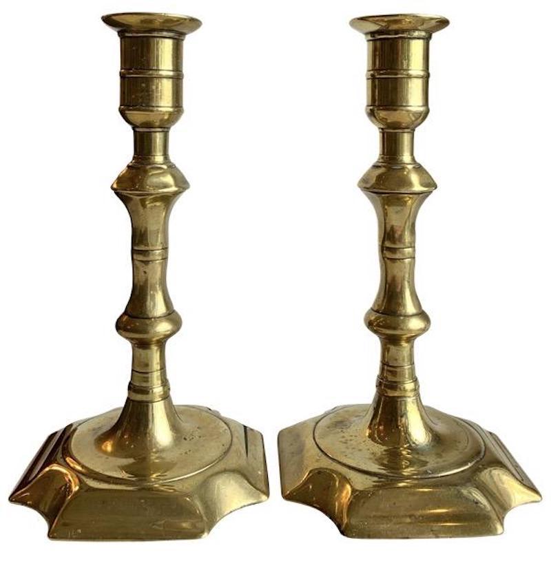 Pair of c. 1730 English Queen Anne turned brass candlesticks with incut corners to the bases. 6.75” h. x 3.75 x 3.75.