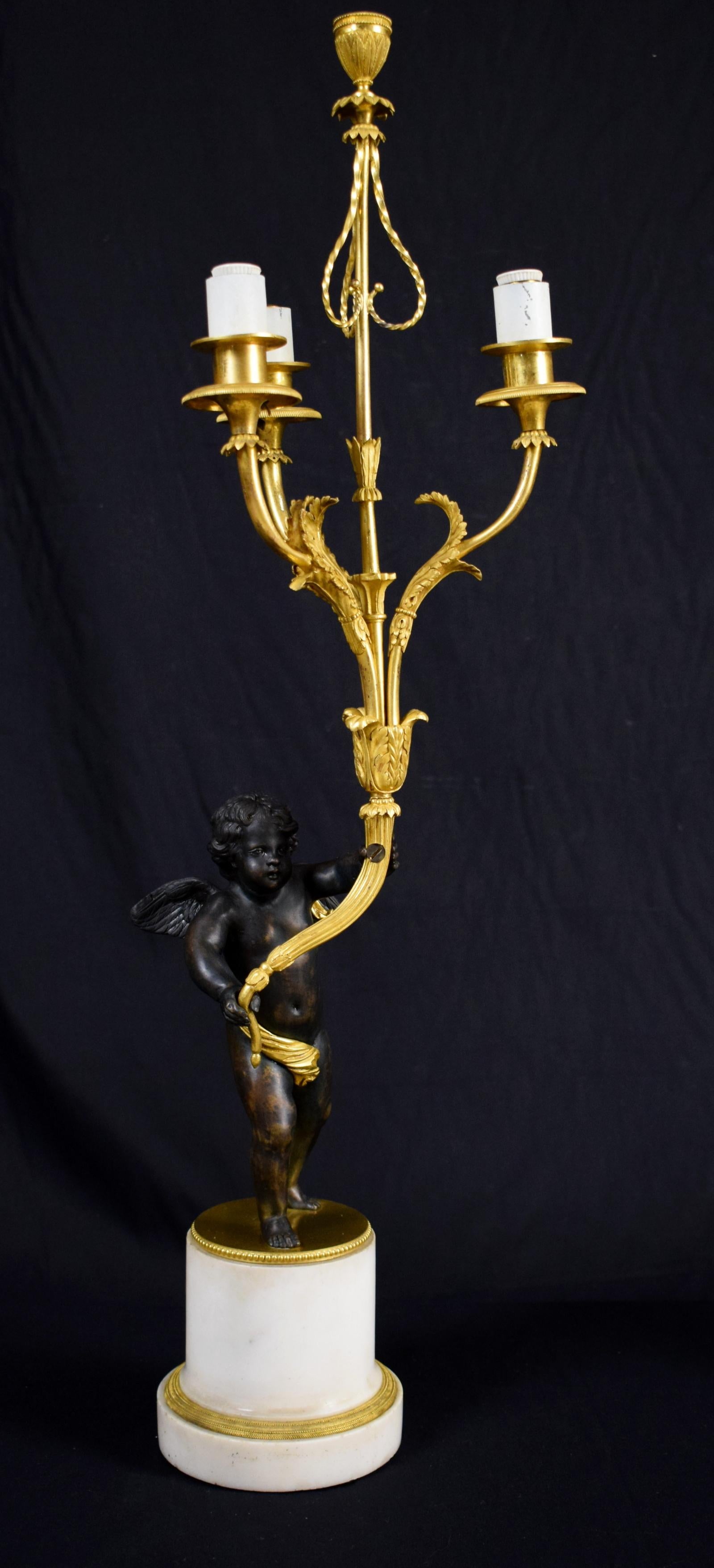 Pair of four-light gilded bronze candlesticks with patinated bronze putti and white marble base,
Second half of the 18th century, France

The pair of delicious candlesticks was made in France in the second half of the 18th century, Louis XVI. The
