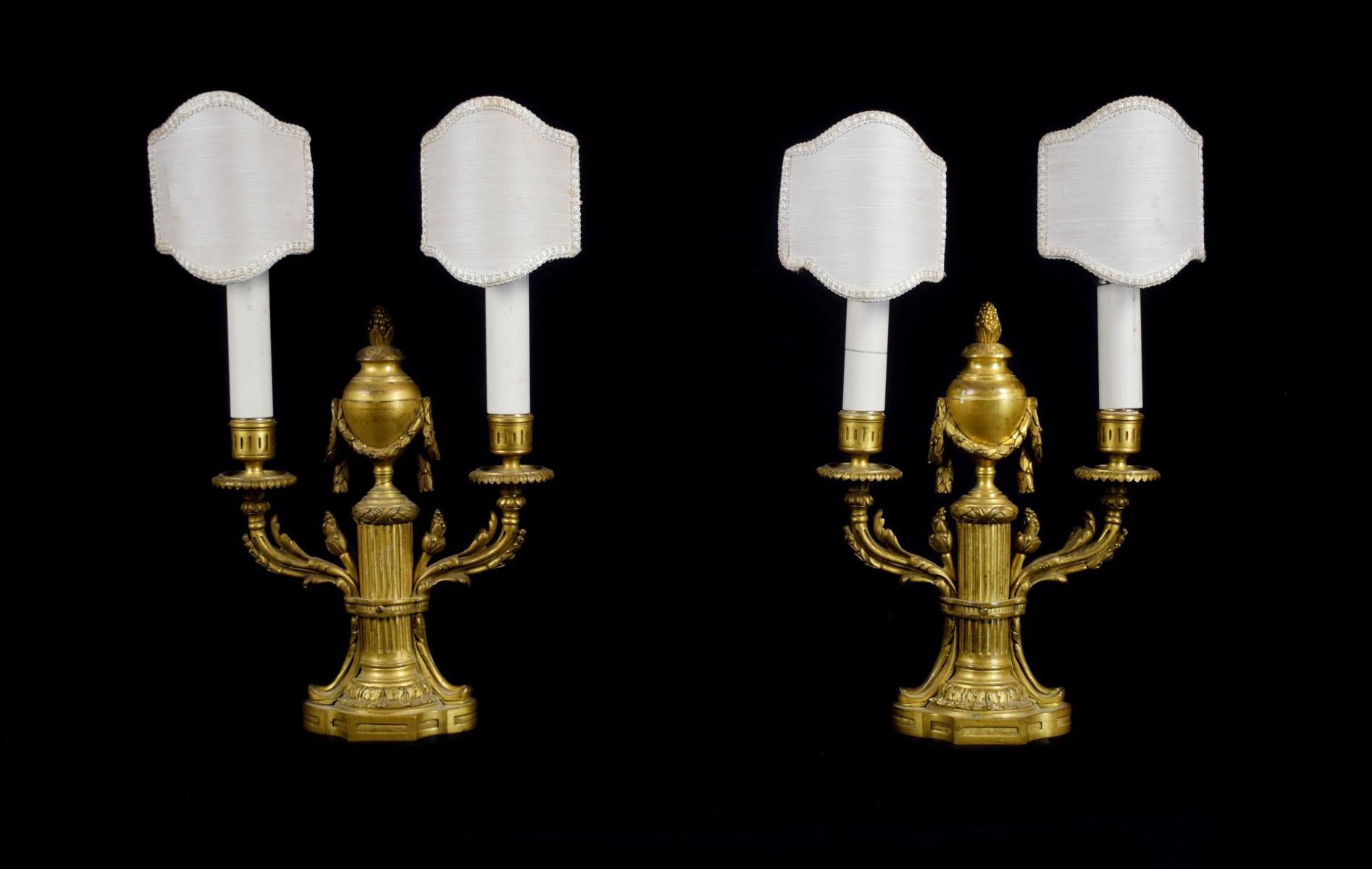 19th century, pair of French Louis XVI two lights gilt bronze candlesticks
sizes: overall height cm 39,5 x height bronze 29 x W 20 x D 9 cm

The fine pair of candlesticks was made in France in the 19th Century in finely chiselled and gilded bronze,