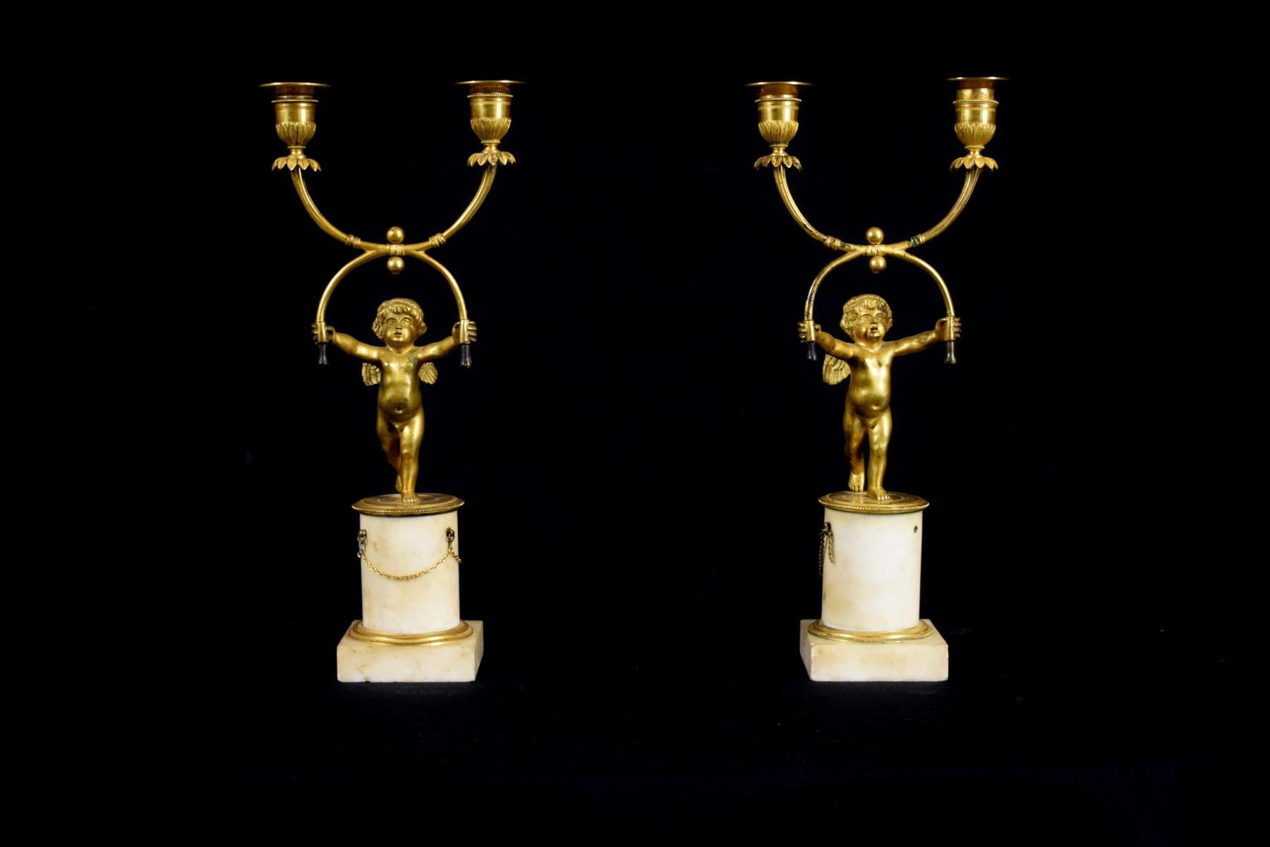 18th century, pair of French two-light gilt bronze candlesticks

Measurement: H total 35 cm; H base 10,5 cm x W 8,2 x 8,2 cm; W putti 16 cm x D 10 cm

The splendid pair of candlesticks was made in France in the 18th century in finely carved bronze