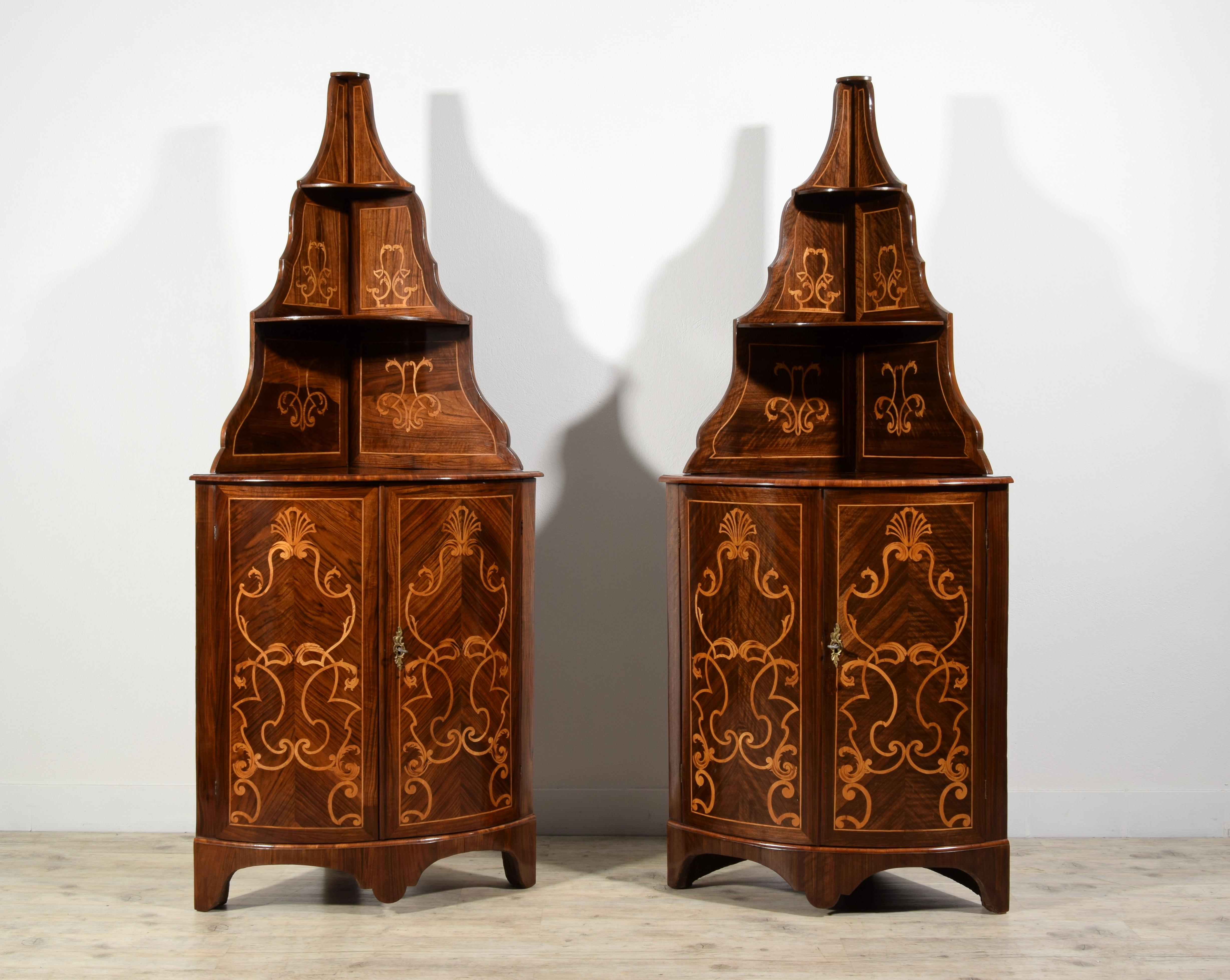 18th century, Pair of Italian Inlay Wood Corner Cabinets 
Measurements: cm H maximum 183 cm x D 56; top H 92 cm
This refined pair of corner cabinets was made in Piedmont around the middle of the 18th century.
The wooden structure is veneered in